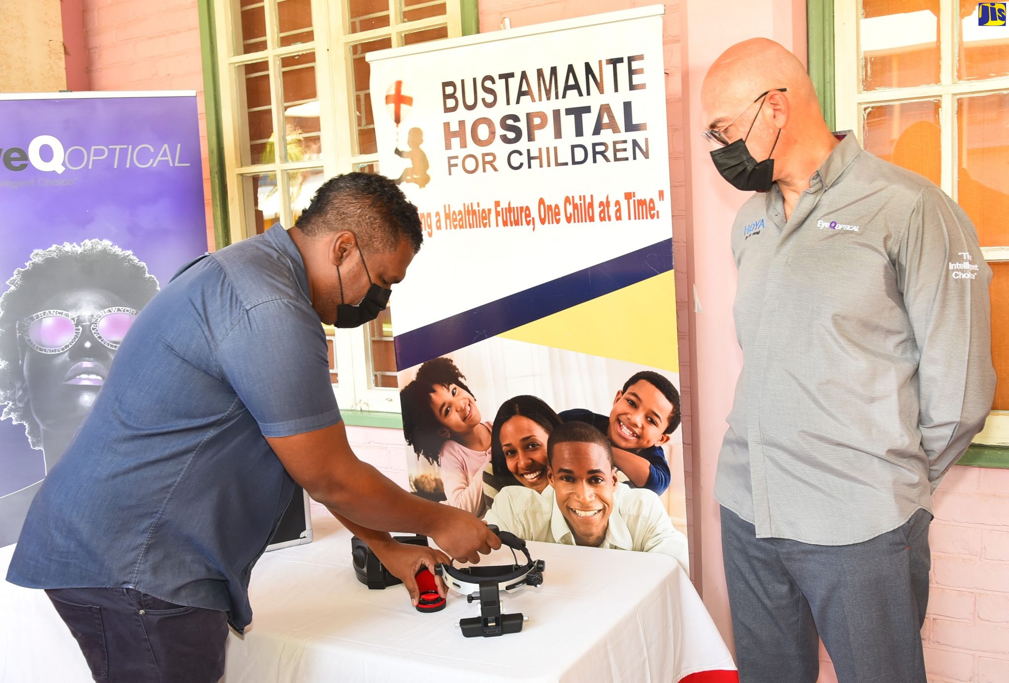Consultant Ophthalmologist, Dr. Leighton Maddan (left), examines the ophthalmoscope, donated by Eye Q Optical to the Bustamante Hospital for Children. Looking on is Chief Executive Officer, Eye Q Optical, Aron Wohl. The equipment was handed over during a ceremony held on October 29, on the compound of the hospital in St. Andrew.