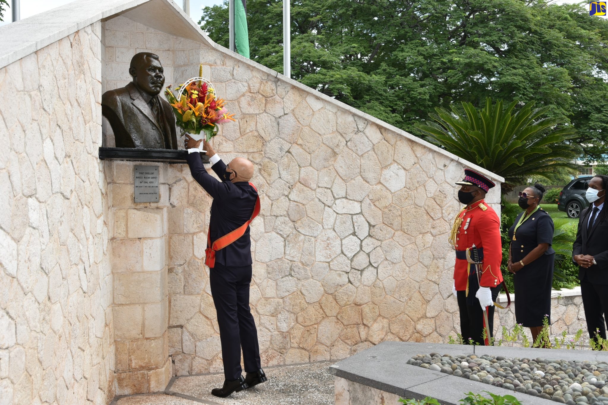 Governor-General, His Excellency the Most Hon. Sir Patrick Allen (left), places a floral arrangement at the monument of the National Hero, the Rt. Excellent Marcus Mosiah Garvey at National Heroes Park in Kingston. Observing the proceedings (from second left) are: the Governor-General’s Aide-de-Camp, Major Dwayne Hill; Minister of Culture, Gender, Entertainment and Sport, Hon. Olivia Grange; and State Minister for Culture, Gender, Entertainment and Sport, Hon. Alando Terrelonge. The event forms part of activities commemorating National Heroes Day being observed on Monday (October 18).
