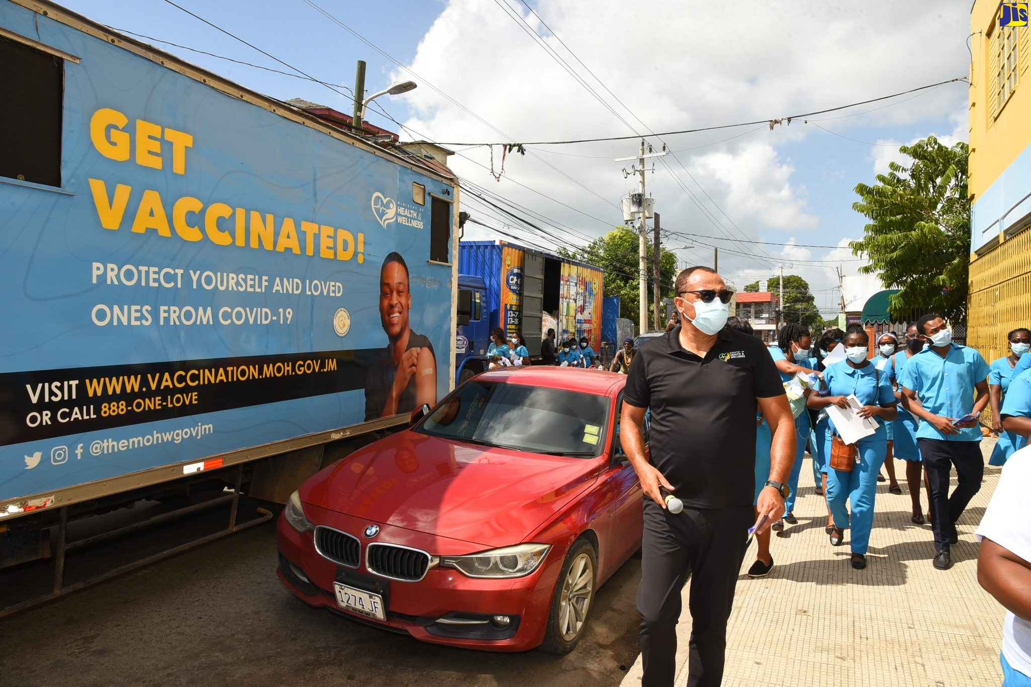 Health and Wellness Minister, Dr. the Hon. Christopher Tufton, heads a group of Community Health Aides during a COVID-19 vaccine public education initiative in Spanish Town, St. Catherine, on October 27. The team also conducted a sensitisation exercise in the town centre where they distributed flyers, pamphlets, masks and T-shirts.