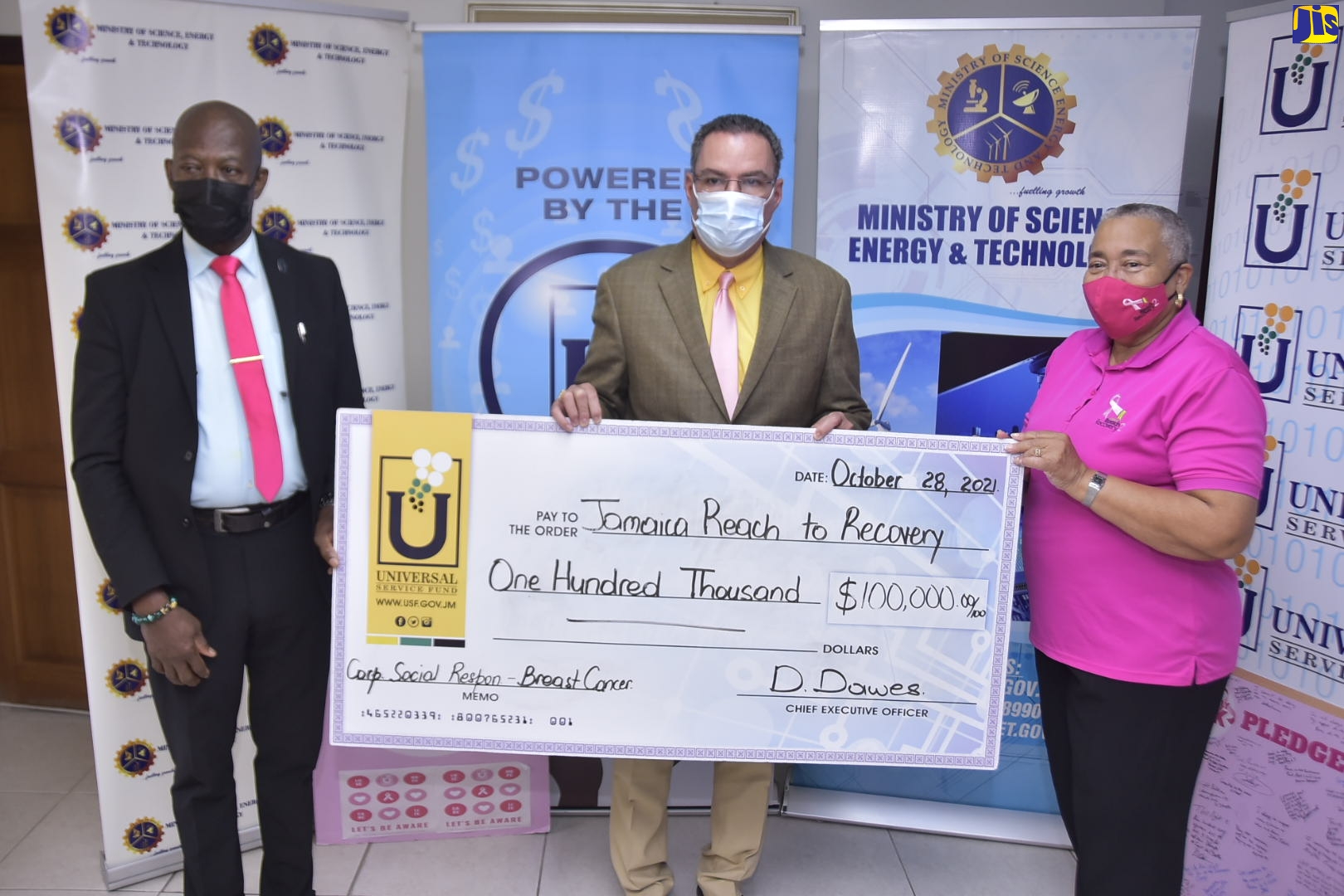 Minister of Science, Energy and Technology, Hon. Daryl Vaz (centre), displays a cheque valued at $100,000, representing a donation from the Universal Service Fund (USF), to Jamaica Reach to Recovery, an affiliate of the Jamaica Cancer Society (JCS). The cheque was handed over at the Minister’s New Kingston offices in St. Andrew on Thursday (October 28). Also pictured are Chief Executive Officer of the USF, Daniel Dawes (left), and Chairman of Jamaica Reach to Recovery, Carolind Graham.