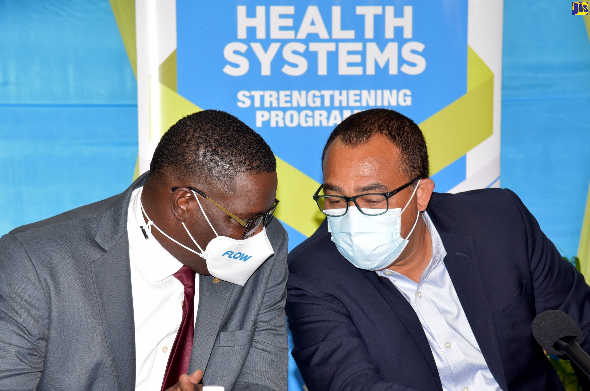 Minister of Health and Wellness, Dr. the Hon. Christopher Tufton (right), converses with Vice President and General Manager, C&W Jamaica Limited, Stephen Price, during today’s (October 28) contract signing between the Ministry and C&W Jamaica Limited for computers and network equipment and technological infrastructure for 105 health facilities. The signing took place at the Ministry’s New Kingston offices.