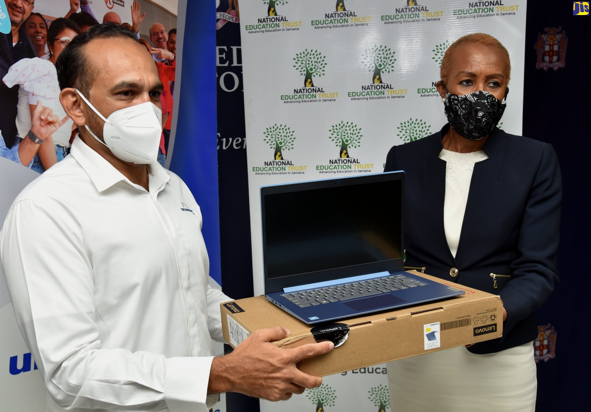 Minister of Education, Youth and Information,  Hon. Fayval Williams (right), receives one of 20 tablets  donated by Unicomer Jamaica Limited, from Managing Director, Mr Edwin Vaquerano, at the Ministry on October 28. The devices have been given to the ‘One Laptop or Tablet Per Child’ Initiative. The donation is valued at $1,608,000 and the tablets will be given to secondary students and primary-school teachers. 
