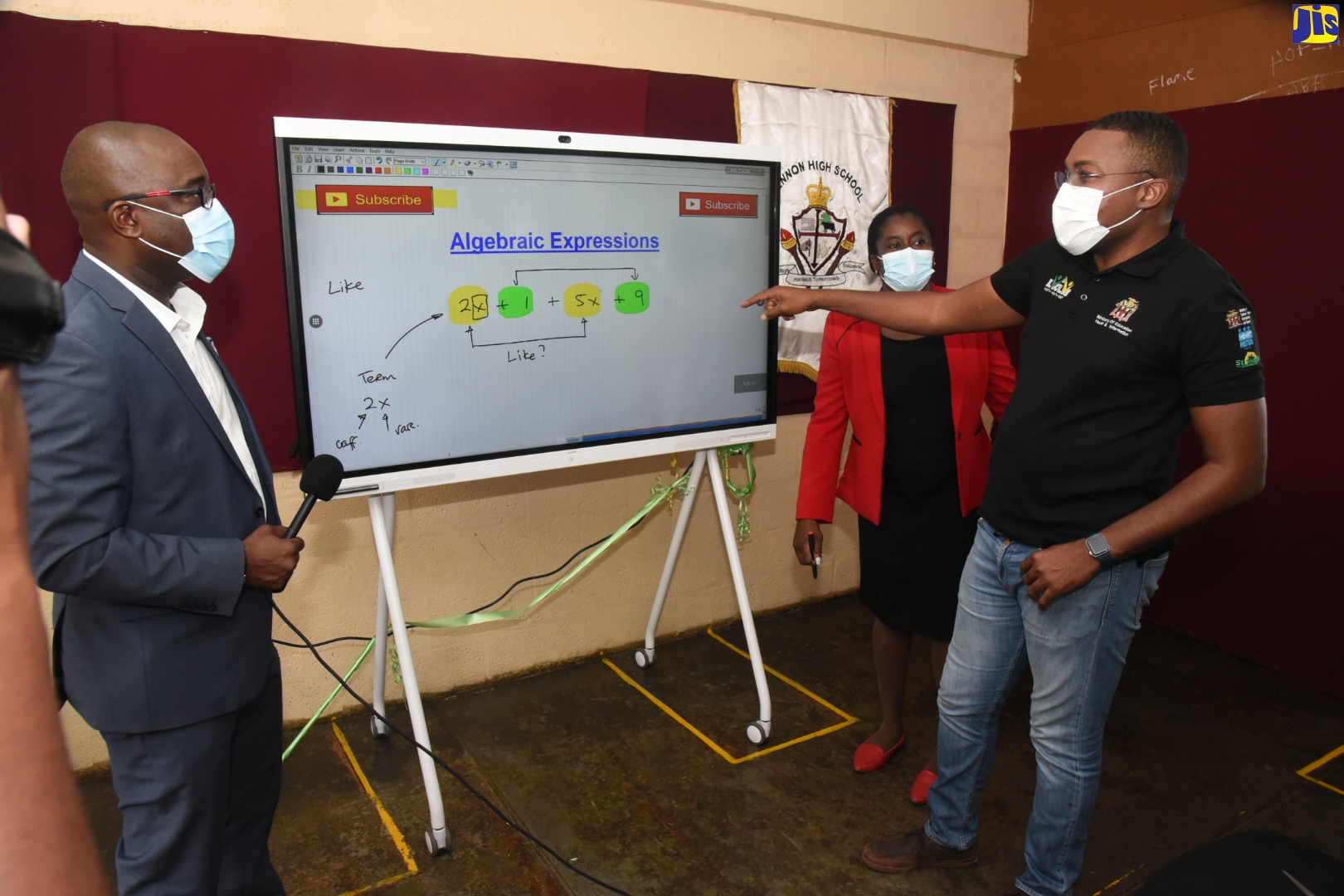 Minister of State in the Ministry of Education, Youth and Information, Hon. Robert Morgan (right), in discussion with Huawei Technologies’ Regional Director, Courtney Hamilton, about the features of the IdeaHub Interactive Panel that the entity donated to Lennon High School in Clarendon. The device was presented to the school’s Acting Principal, Tanesha Powell (centre), on Thursday (November 11), during a  handover ceremony at the institution, which is situated in Clarendon North Central, for which Mr. Morgan is the Member of Parliament.
