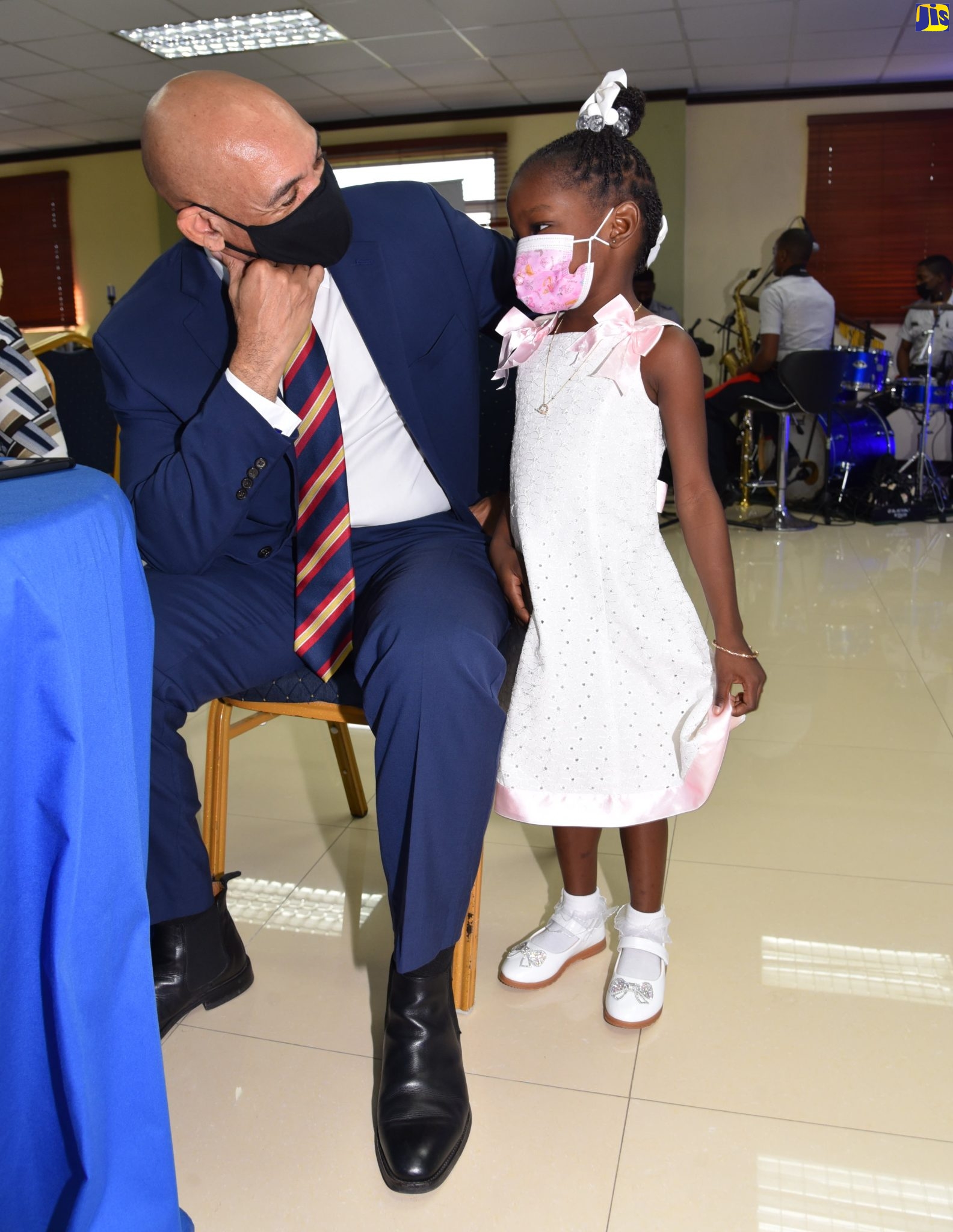 Commissioner of Police, Major General Antony Anderson (left), interacts with little Danella Williams, daughter of late police constable, Dane Williams. Occasion was a  luncheon to honour fallen officers, held at the Office of the Commissioner in St. Andrew on Tuesday (November 23).