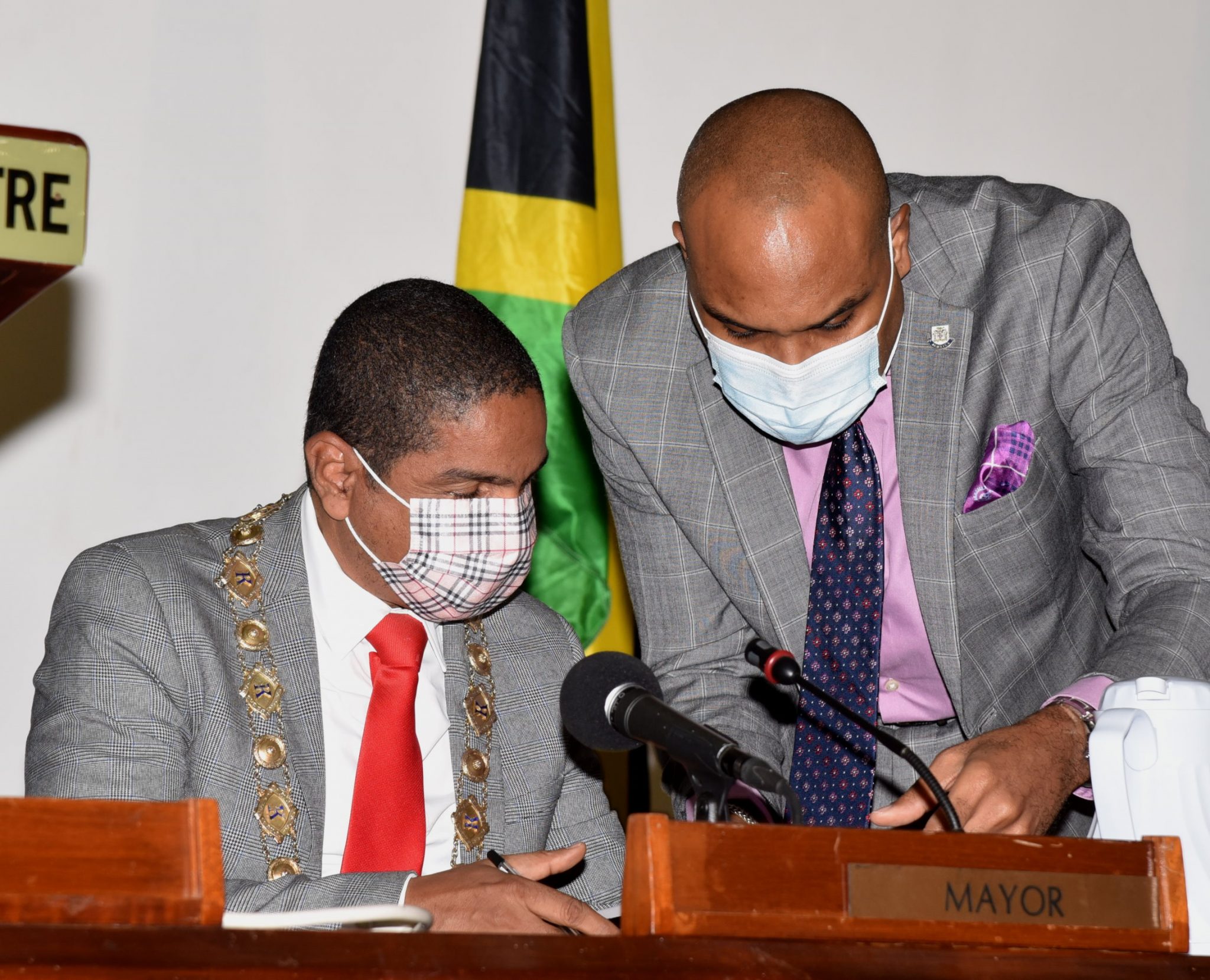 Mayor of Kingston, Senator Councillor Delroy Williams (left), consults with Chief Executive Officer, Kingston and St. Andrew Municipal Corporation, Robert Hill, during a recent meeting of  the Kingston and St. Andrew Municipal Corporation, at the Jamaica Conference Centre in downtown Kingston.

