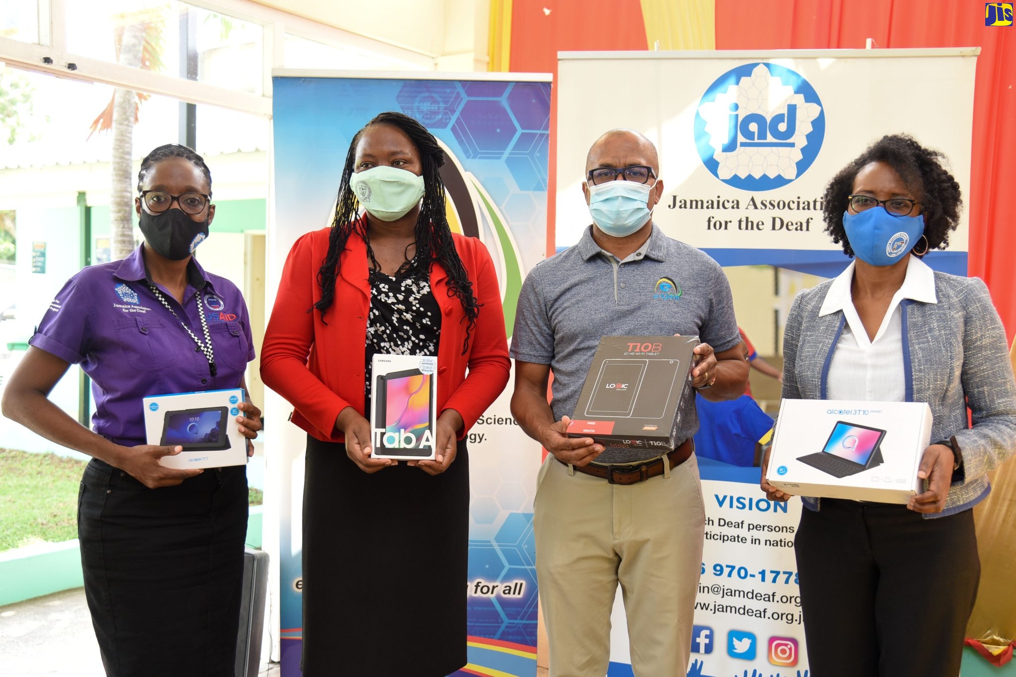 Director of Education and Training at Jamaica Association for the Deaf, Trisha Ewen-Smith; Principal of Lister Mair Gilby High School for the Deaf, Stacy-Ann Dockery; Acting Chief Executive Officer, e-Learning Jamaica Company Limited, Andrew Lee; and Director, Business Development Division, Jamaica Association for the Deaf, Deniese Badroe, display tablets donated by e-Learning Jamaica to the Jamaica Association for the Deaf, as part of the agency’s Corporate Social Responsibility. The tablets were handed over during a ceremony held on December 10, at the Lister Mair Gilby High School for the Deaf in Kingston. The devices will support online teaching and learning at schools for the hearing impaired.