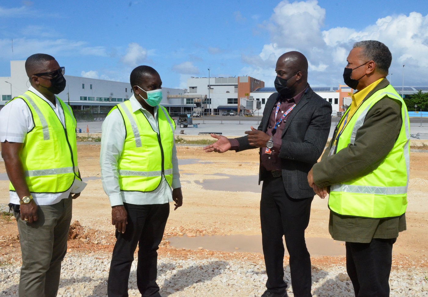 Transport and Mining Minister, Hon. Robert Montague (second left) listens attentively to Chief Executive Officer of MBJ Airports Limited, Shane Munroe (second right) during a tour of the Sangster International Airport (SIA) in Montego Bay, St. James on Thursday (December 17). Looking on (from left) are Member of Parliament for St. James Central, Heroy Clarke and Chief Executive Officer of the Airports Authority of Jamaica (AAJ), Audley Deidrick. 