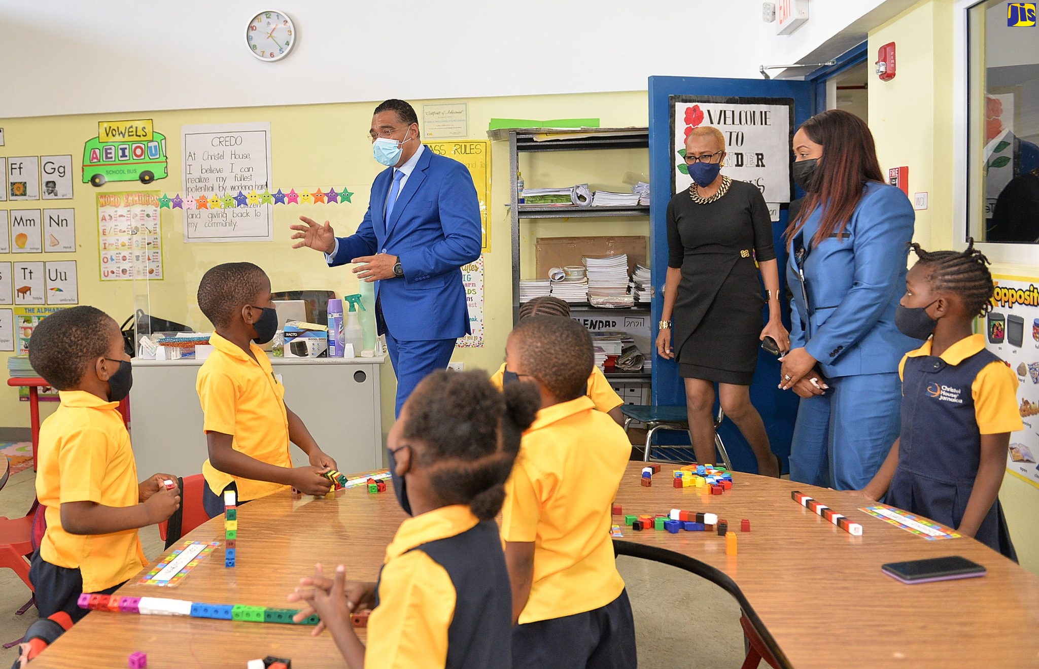 Prime Minister, the Most. Hon. Andrew Holness (left), greets kindergarten students of Christel House Jamaica School in Twickenham Park, St. Catherine, following the institution’s official opening on Friday (December 10). With him are Minister of Education, Youth and Information, Hon. Fayval Williams (centre), and the school’s Principal, Tracey Ann Anderson.