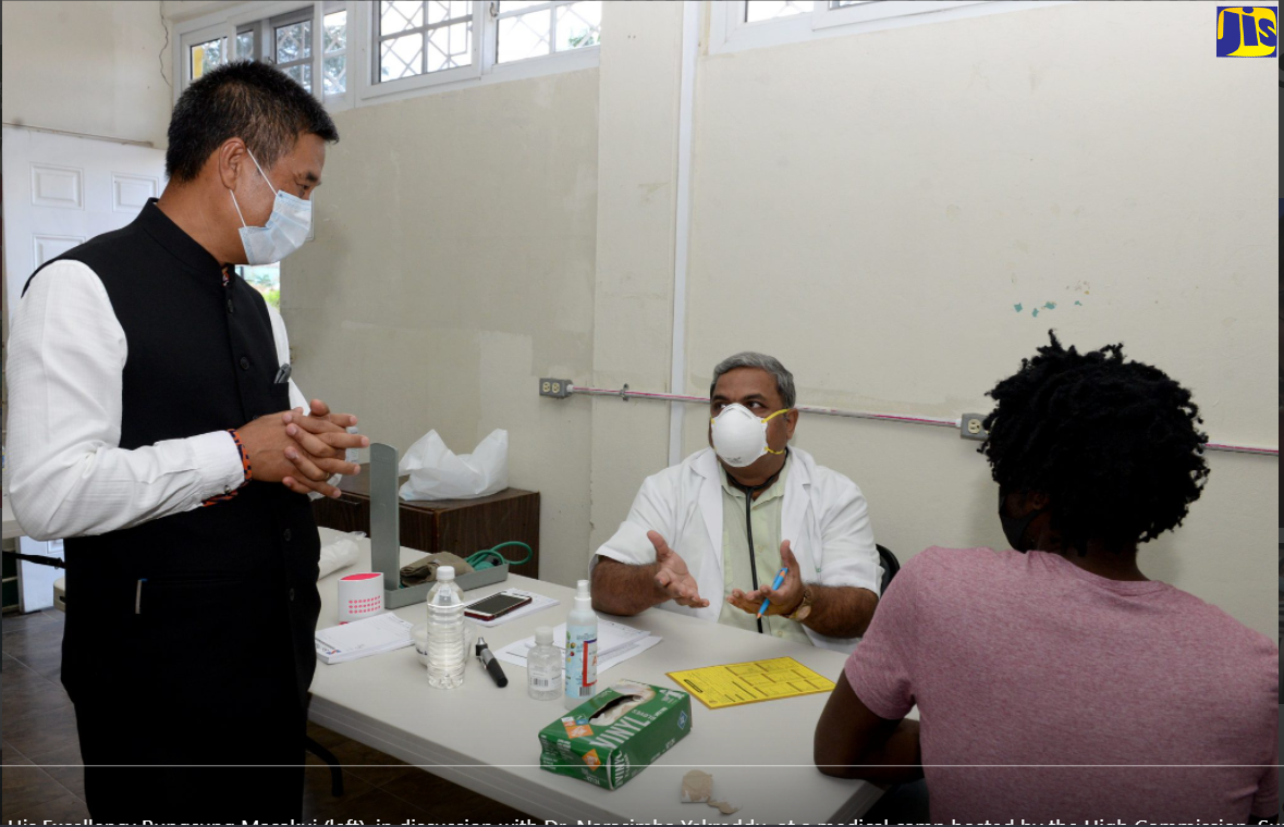 High Commissioner of India to Jamaica, His Excellency Runsung Masakui (left) is in discussion with Dr. Narasimha Yekreddu at a medical camp hosted by the High Commission earlier this year at the Constant Spring Library, 5 Cassava Piece Road, Kingston 8. Seated at right is a patient who visited the camp.