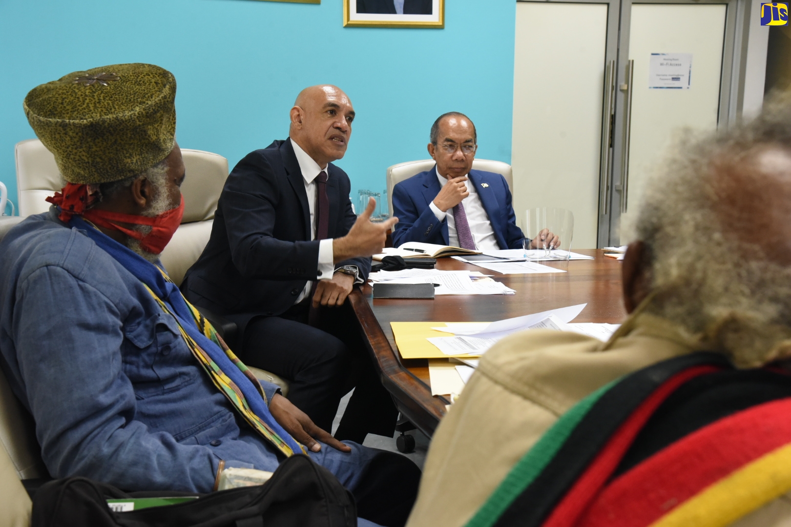 Deputy Prime Minister and Minister of National Security, Hon. Dr. Horace Chang (right), listens as Police Commissioner, Major General Antony Anderson (second right), outlines a point in discussion with delegates of the Rastafari Coalition of Jamaica, during a meeting at the Ministry in Kingston on Thursday (December 9).