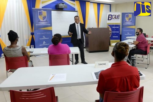 Director, Corruption Prevention, Stakeholder Engagement and Anti-Corruption Strategy at the Integrity Commission, Ryan Evans (centre, standing), addresses participants in the Anti-Corruption and Good Governance Sensitisation Workshop, held recently, at the offices of the Betting, Gaming and Lotteries Commission (BGLC) in Kingston.