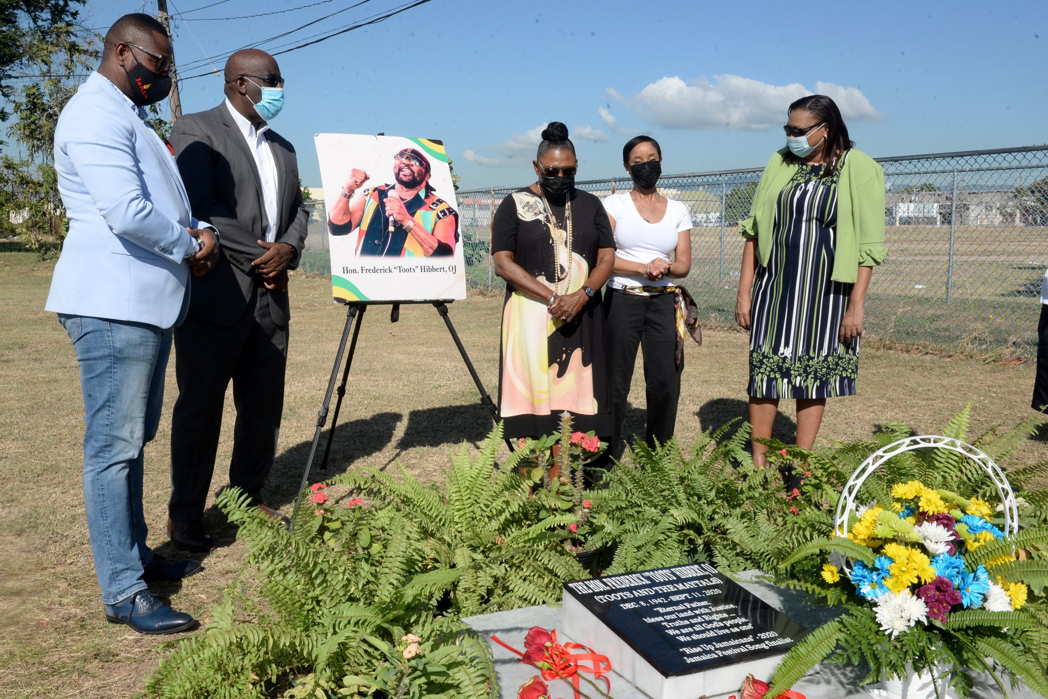 Minister of Culture, Gender, Entertainment and Sport (centre) Hon. Olivia Grange, pays respects to late reggae icon Toots Hibbert at a wreath laying ceremony in celebration of his birthday, held on December 8 at National Heroes Park in Kingston. Also participating in the ceremony (from left) are: Chairman of Jamaica Reggae Industry Association (JaRIA) Ewan Simpson; Chairman, Entertainment Advisory Board, Howard McIntosh; Mr. Hibbert’s granddaughter, Cressida Rattigan; and Acting Executive Director, Jamaica Cultural Development Commission (JCDC), Lillian Reid.