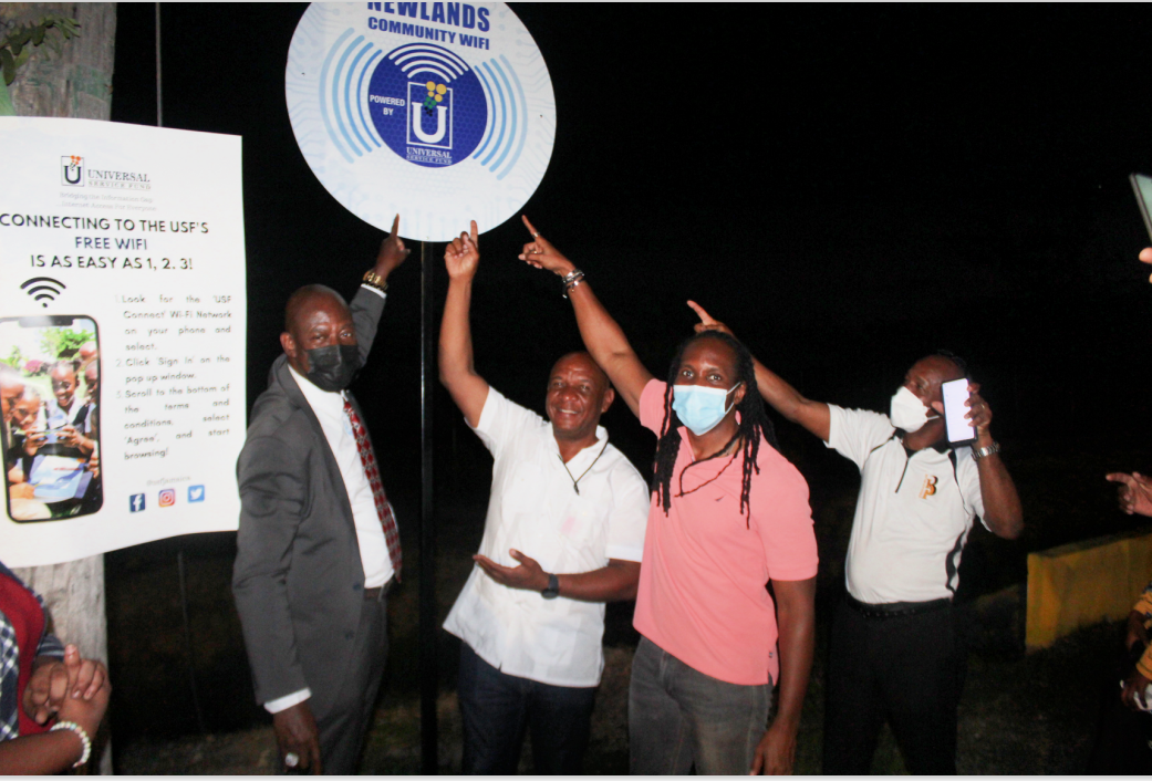 Chief Executive Officer of the Universal Service Fund (USF) Daniel Dawes (left), and Member of Parliament for St. Catherine East Central Hon. Alando Terrelonge (third left), welcome the launch of a free wi-fi hotspot for the community of Newlands, in Portmore, St. Catherine, recently. Others pictured from left are residents of the area, Lennox Hinds and Delroy Dobey.  Photo: contributed