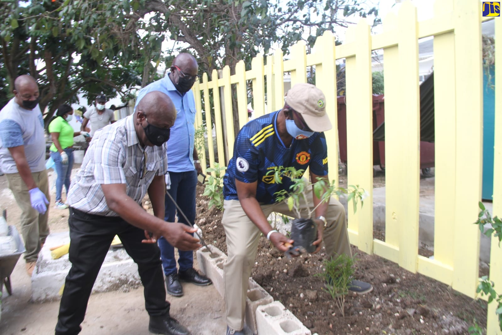 Minister of Local Government and Rural Development, Hon. Desmond McKenzie (right) and Mayor of Falmouth, Colin Gager (left), prepare to plant a tree on the grounds of the Trelawny Infirmary in Falmouth, during a recent visit to the facility by the Minister and his team as a part of Local Government Month activities in November.
