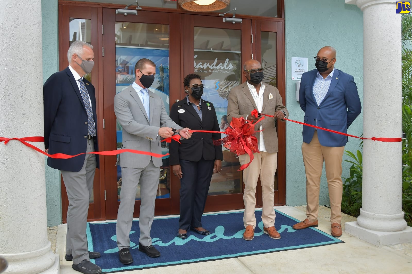 Minister of Tourism Hon. Edmund Bartlett (fourth left) and Executive Chairman of Sandals International Resorts, Adam Stewart (second left) seen here at the official ribbon-cutting ceremony, celebrating an expansion of the Sandals Royal Caribbean Resort, Montego Bay, St. James on December 23. Others in photo from (L-R) are: Chief Executive Officer of Sandals, Gebhard Rainer; General Manager of Sandals Royal Caribbean, Dawn Smith; and Chief Strategist/Senior Adviser in the Ministry of Tourism, Delano Seiveright.