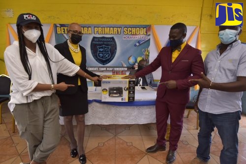 Minister of Education and Youth, Hon. Fayval Williams (second left) hands over a printer from the Usain Bolt Foundation to the Principal of Bethabara Primary School, Cecil Hamilton (second right), during a function held at the school located in Newport, Manchester on January 21. Others from left are: Member of Parliament, Manchester Central, Rhoda Moy-Crawford and Councillor, Knockpatrick Division, Cleon Francis. The Usain Bolt Foundation will be donating 100 printers and 20 projectors to primary schools across Jamaica.