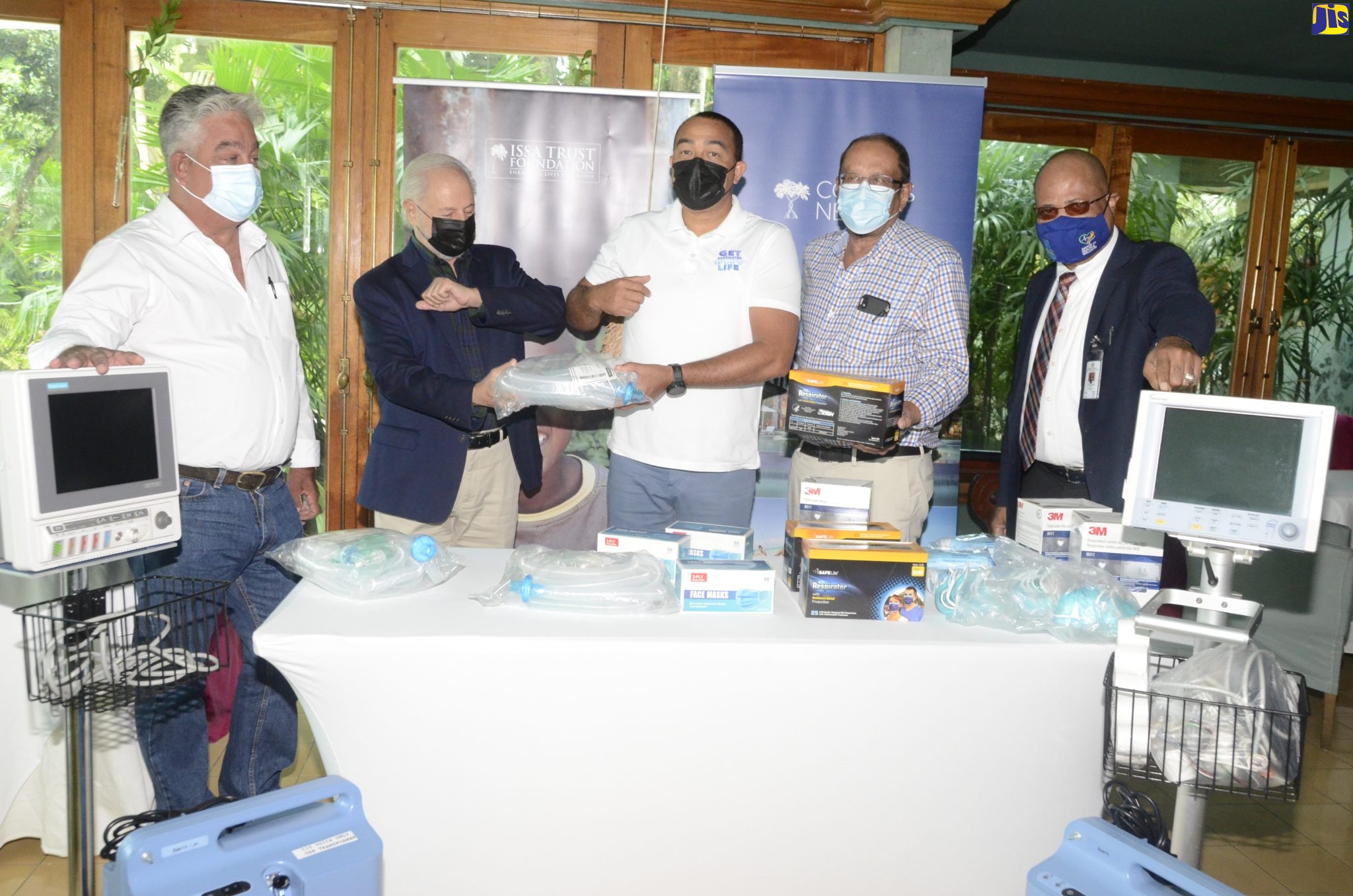 Minister of Health and Wellness, Dr. the Christopher Tufton (centre), accepts a donation of medical supplies and equipment from Chairman of the Issa Trust Foundation (ITF), Paul Issa, during a handover ceremony at Couples Resort in Negril, Westmoreland on Friday (January 7). Also participating (from left) are: Chairman, Western Regional Health Authority (WRHA), Eric Clarke; Foundation Board Member, Howard Mitchell; and WRHA Regional Director, St. Andrade Sinclair.