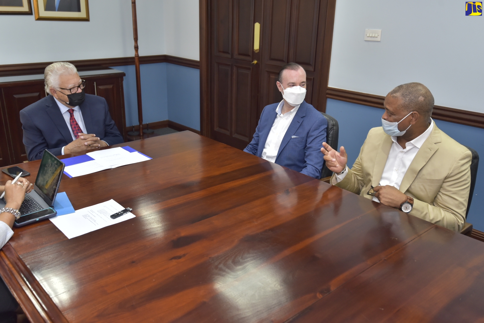 Minister of Labour and Social Security, Hon. Karl Samuda (left), listens to a comment from newly appointed Country Manager, Bahia Principe Resort Jamaica, Brian Sang (right), during a courtesy call on the Minister at the National Insurance Fund (NIF) offices in New Kingston on January 11. Also sharing in the discussion is Chief Operating Officer, Bahia Principe Hotels & Resorts, Antonio Teijeiro. Mr. Sang is the first Jamaican to hold this position and assumed duties effective January 3.