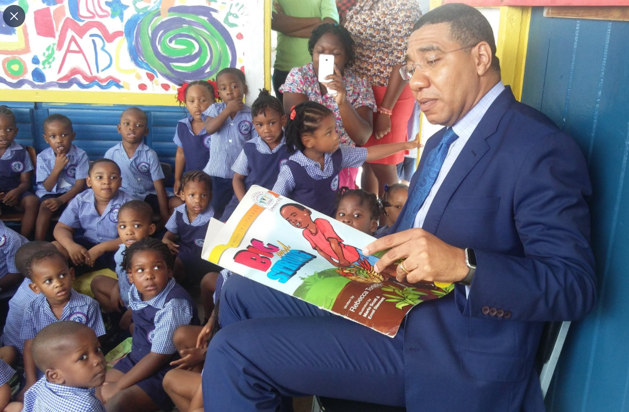 Prime Minister, the Most Hon. Andrew Holness, reading to children at Jamaica House Basic School on Read Across Jamaica Day in 2017. (FILE)