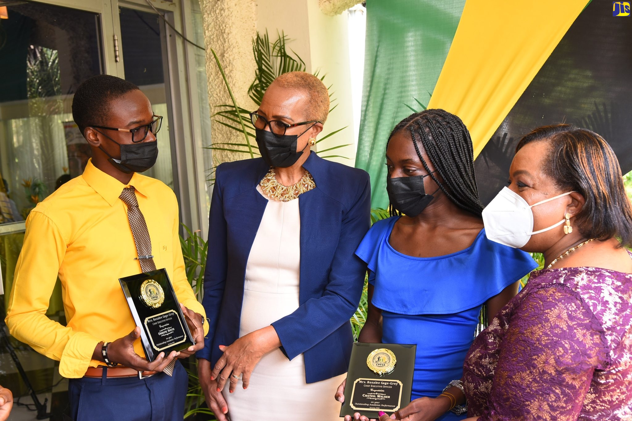 Minister of Education and Youth the Hon. Fayval Williams (second left) greets two of the awardees during the Child Protection and Family
Services Agency's 10th Annual Educational Achievement Awards Ceremony. The awardees are Mr. Duvere Ford (left) and Miss Chaneil Walker (second right). Chief Executive Officer of CPFSA Mrs. Rosalee Gage-Grey is at right. The ceremony was held on Friday (January
28