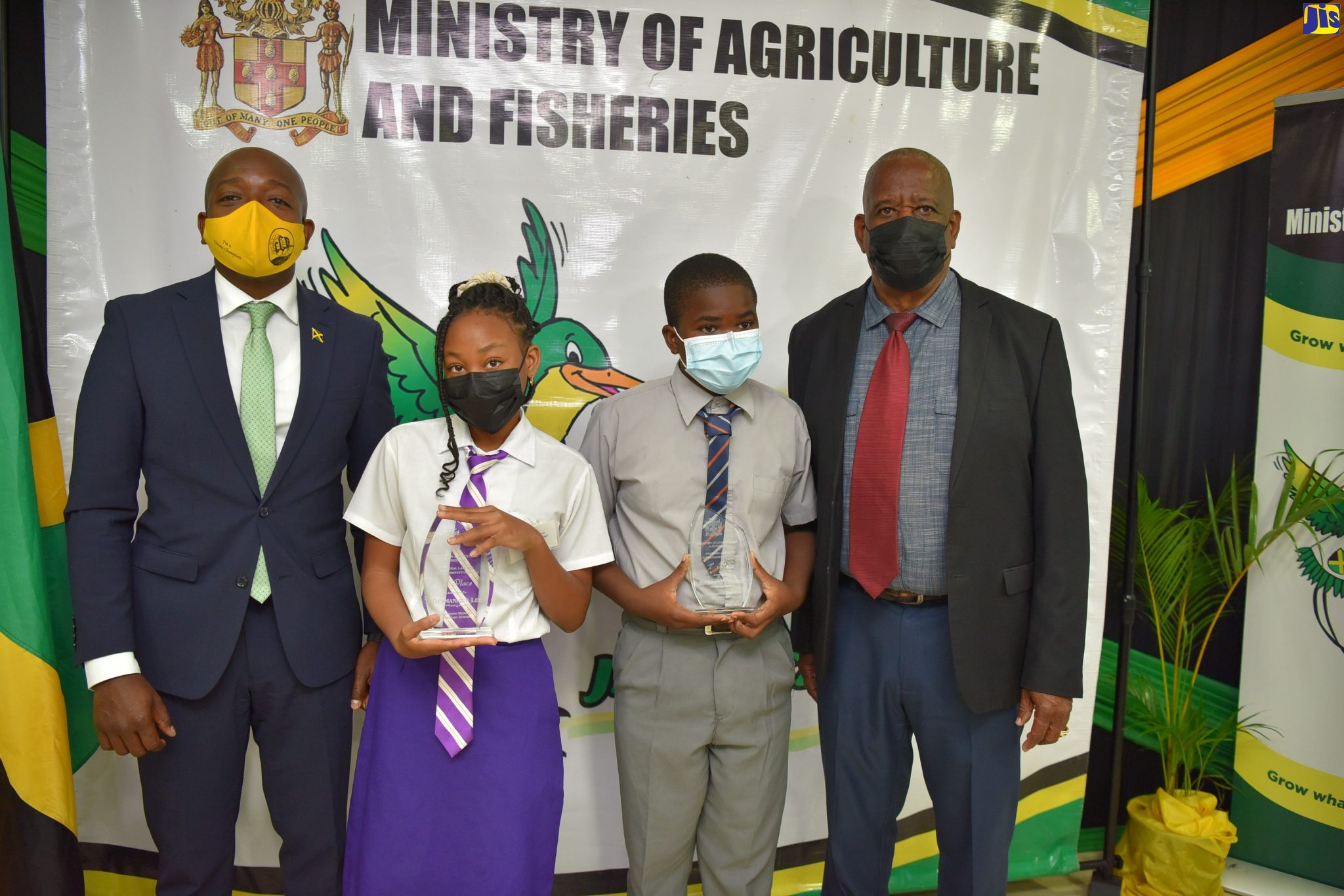 Minister of Agriculture and Fisheries, Hon. Pearnel Charles Jr. (left) and Minister of State in the Ministry, Hon. Franklin Witter (right) with first place winners in the Praedial Larceny Essay and Jingle Competition, Dermanique Lee of Chetwood Memorial Primary School in St. James (second left); and Kriston Ferguson of Norman Gardens Primary in Kingston. The virtual awards ceremony was held on January 21.