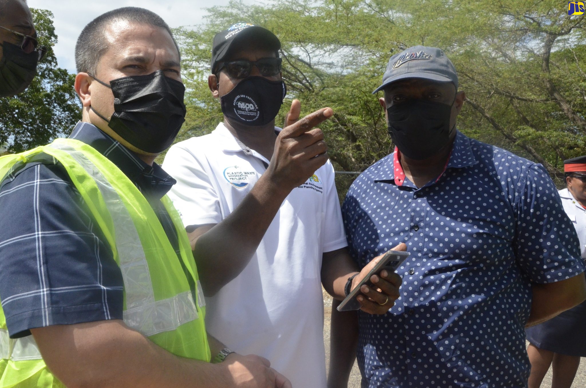 Minister without Portfolio in the Ministry of Economic Growth and Job Creation (Water, Environment and Climate Change),  Senator the Hon.  Matthew Samuda (left), and Commissioner of Mines in the Mines and Geology Division of the Ministry of Transport and Mining, Roy Nicholson (right),  listen as Senior Manager of the Environmental Sub-Division of the National Environment and Planning Agency (NEPA), Richard Nelson (centre), outlines the dangers of illegal sand mining. Occasion was a recent visit by the Minister to the community of Great Bay in St. Elizabeth, in the wake of illegal sand-mining concerns by residents.