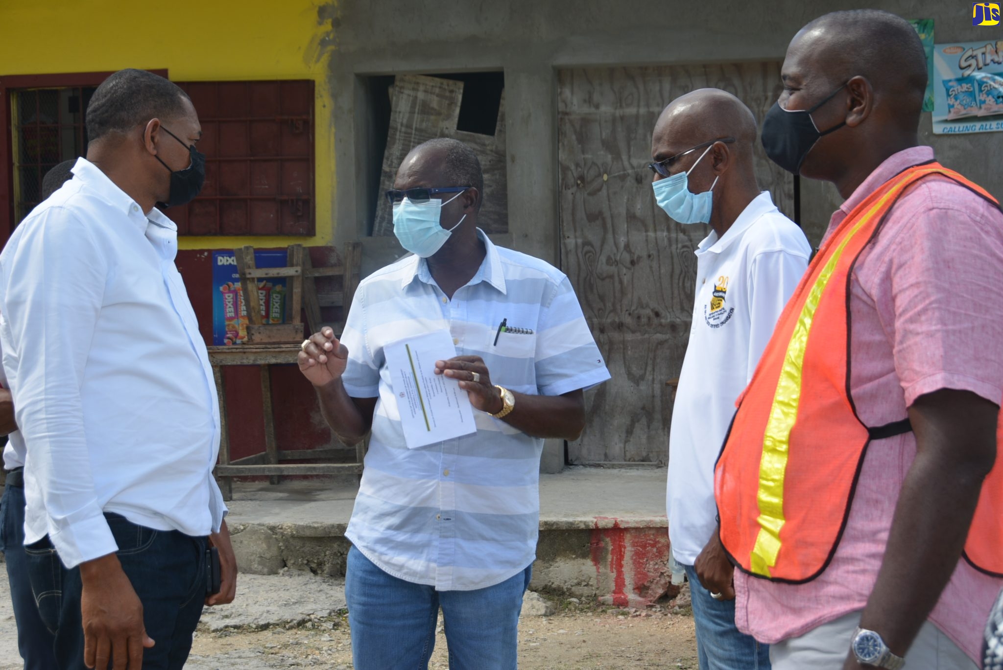 Minister without Portfolio in the Ministry of Economic Growth and Job Creation, Hon. Everald Warmington (second from left), makes a point to  Hanover Eastern Member of Parliament, Dave Brown (left), during a tour of sections of the parish on Wednesday (February 9) to assess road infrastructure. Looking on is National Works Agency’s (NWA) Regional Manager, Robert Francis, and the NWA’s Parish Manager, Gareth Bernard.