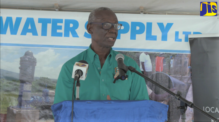 Minister of Local Government and Rural Development, Hon. Desmond McKenzie, addresses the commissioning of a water supply system in Top Aberdeen, St. Elizabeth recently.