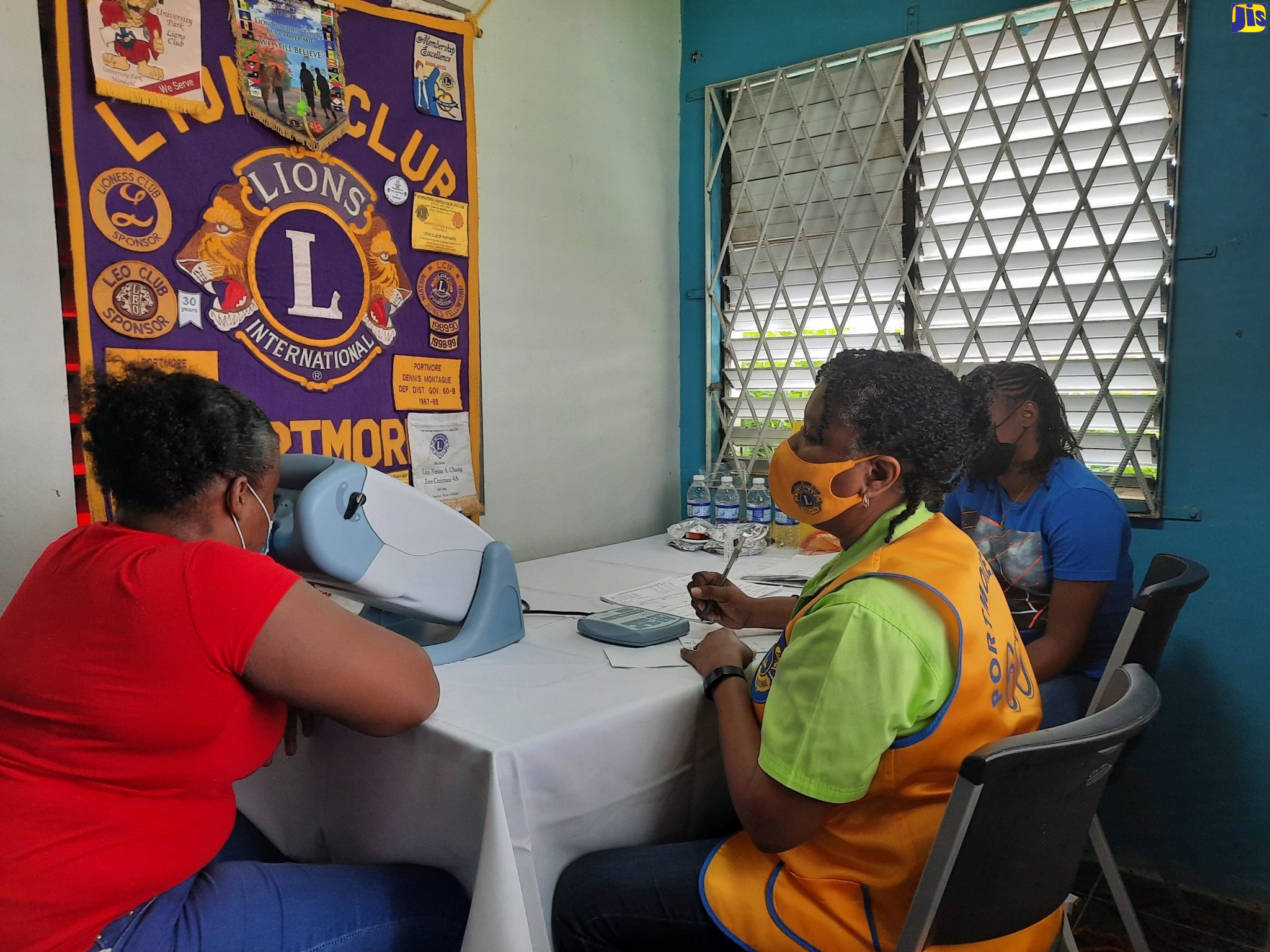 Ann-Marie Vassal Barnes from the Lion’s Club of Portmore (right), conducts eye-screening at a free clinic staged by the Kiwanis Club of North Spanish Town on Saturday (February 12), at the Angel’s Grove Community Centre in the parish.