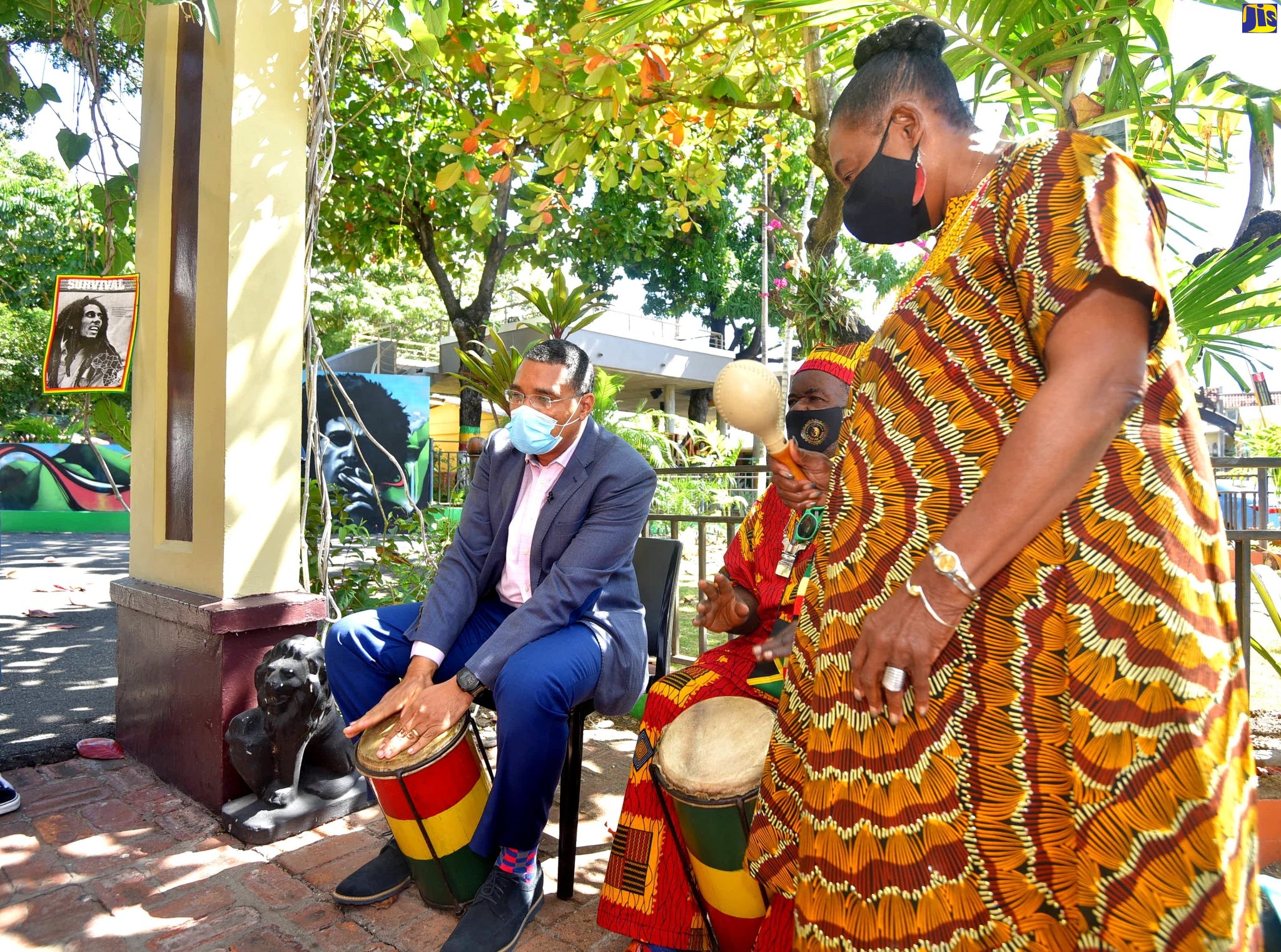 Prime Minister the Most Hon. Andrew Holness (left), plays drums with percussionist Bongo Herman (centre), while Minister of Culture, Gender, Entertainment and Sport, Hon. Olivia Grange (right), plays the shaker. Occasion was the recent Rita Marley: Mystic of a Queen Exhibition, held at the Bob Marley Museum in St. Andrew.