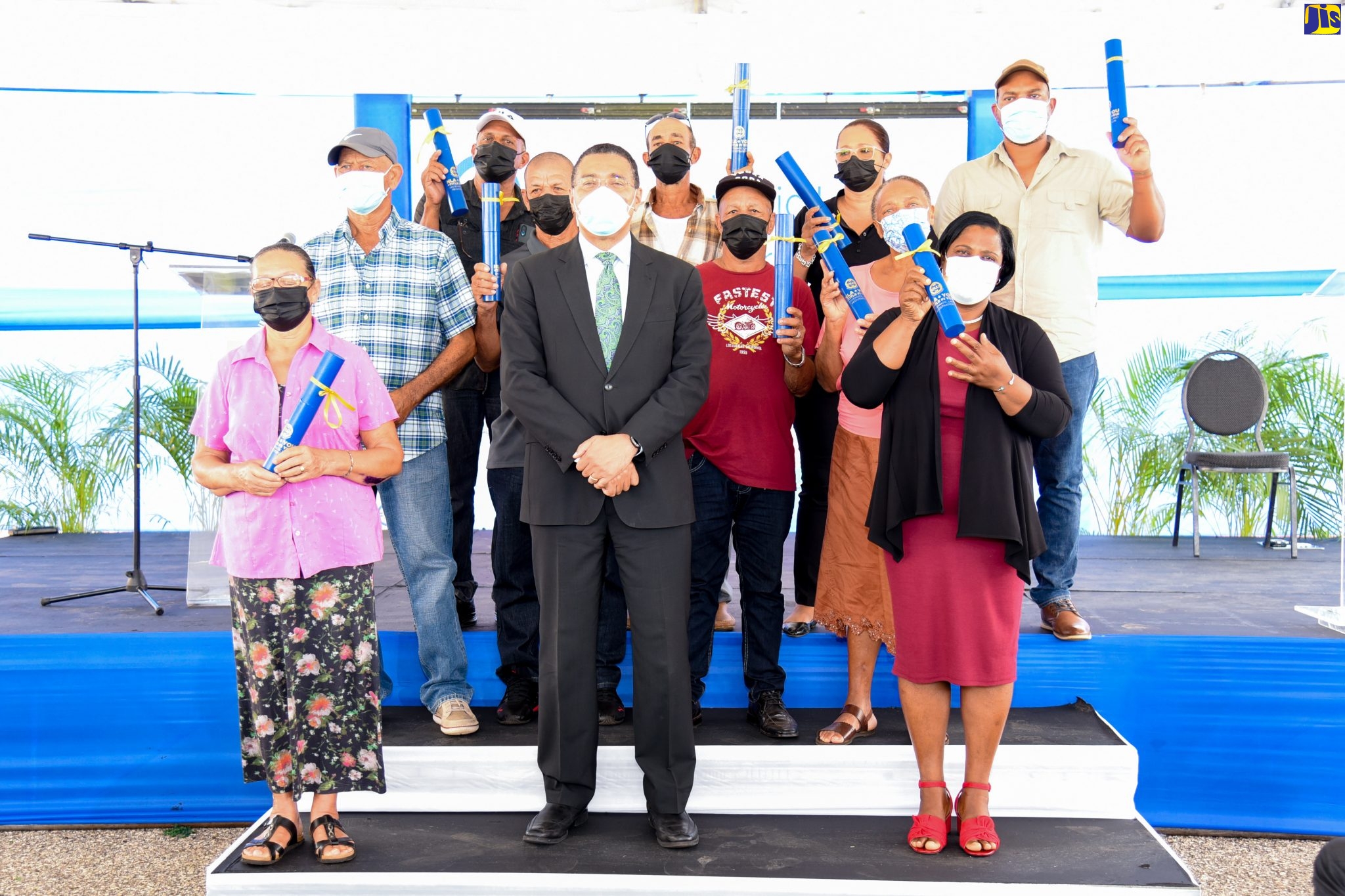 Prime Minster, the Most Hon. Andrew Holness (centre, front row), with landowners in St. Elizabeth who were recently presented with certificates of title under the under the National Land Agency (NLA) Systematic Land Registration (SLR) Programme. The presentation ceremony was held at Newell High School in the parish.