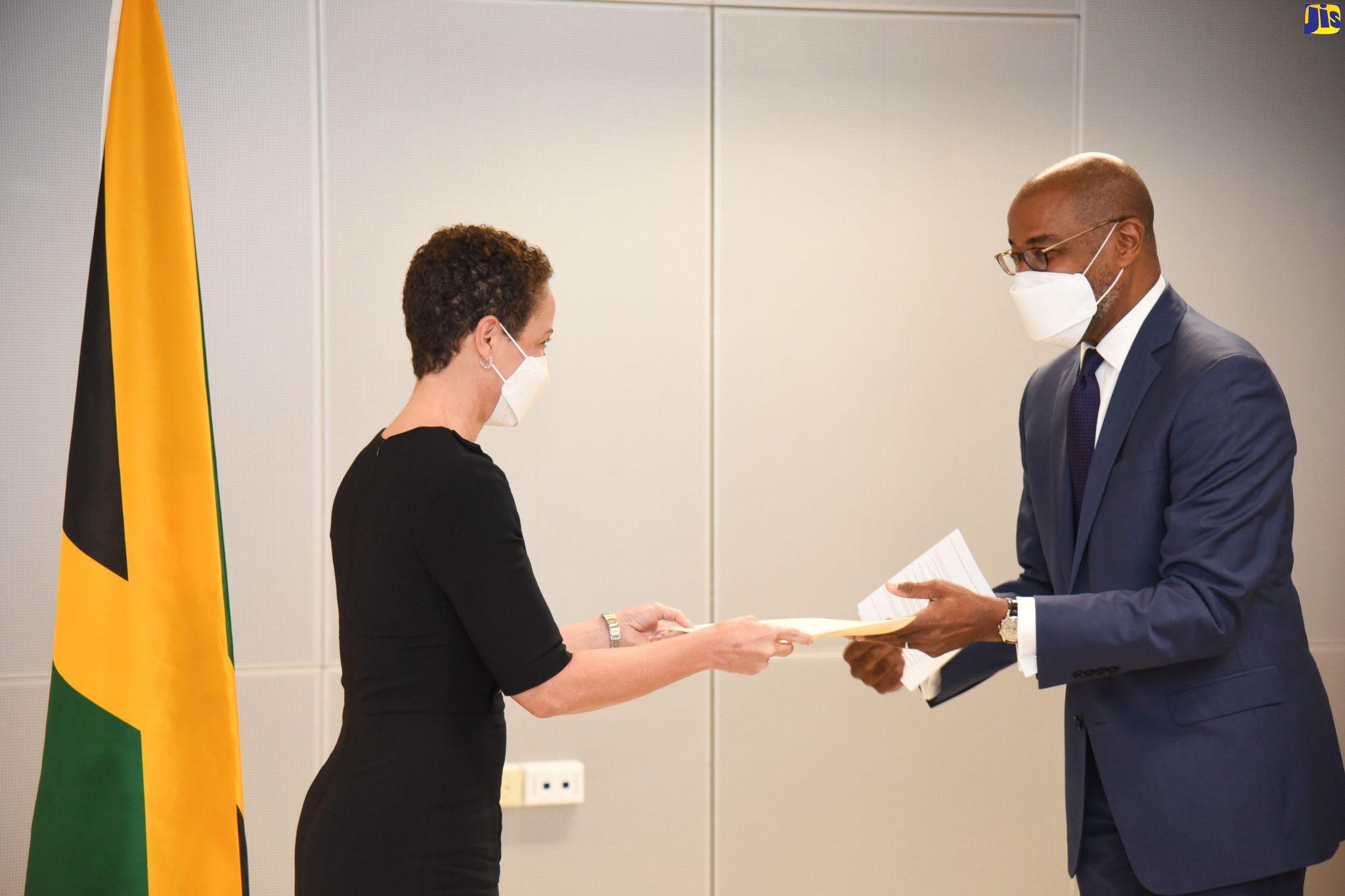 Minister of Foreign Affairs and Foreign Trade, Senator the Hon. Kamina Johnson Smith (left), accepts copies of Letters of Credentials of 10 Ambassadors/High Commissioners-designate from Director of Protocol in the Ministry, Ambassador Ricardo Allicock, at the Ministry in Kingston on March 8. The 10 Ambassadors/High Commissioners-designate are from Croatia, Korea, Netherlands, Ireland, Sri Lanka, Turkey, Iran, Austria, Thailand and Ghana.