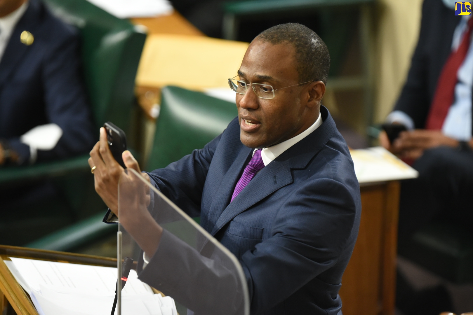AWP 6593
Minister of Finance and the Public Service Dr. the Hon. Nigel Clarke, completes a transaction using the Jamaica Digital Exchange (JAM-DEX) mobile application, while delivering the opening presentation in the 2022/23 Budget Debate in the House of Representatives on Tuesday (March 8) under the theme: ‘Recovery, Reform and Restoration’. JAM-DEX is the name of Jamaica’s Central Bank Digital Currency (CBDC).