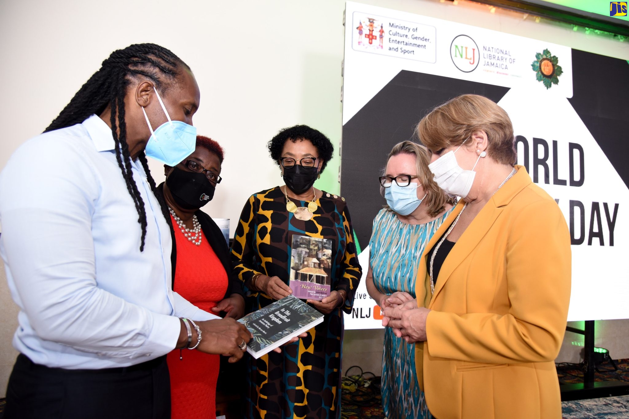 Minister of State in the Ministry of Culture, Gender, Entertainment and Sport, Hon. Alando Terrelonge, examines a book of poetry at the commemorative ceremony for World Poetry Day 2022 – the launch of the National Library of Jamaica (NLJ) Jamaica Poetry Archive (JPA) – on Monday (March 21),  at The Jamaica Pegasus hotel, Kingston. Pictured (from second left) are National Librarian, NLJ, Beverley Lashley; Chair of the Board of Management, NLJ, Joy Douglas;  Canadian High Commissioner to Jamaica, Emina Tudakovic; and Advisor, Communication and Information, UNESCO Cluster Office for the Caribbean, Isabel Viera Bermudez. The event also featured the launch of the NLJ’s Poet Laureate of Jamaica Poetry Competition.     