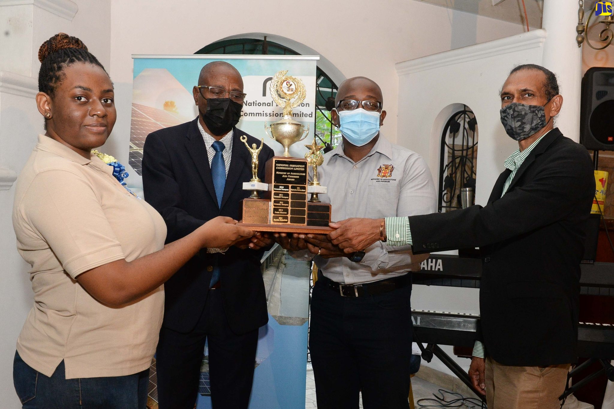 Minister of Agriculture and Fisheries, Hon. Pearnel Charles Jr. (right), presents Tiana Gordon with a tertiary scholarship from the National Irrigation Commission (NIC)for the period 2020/21. The presentation was made during a function held on March 24 at Hotel Four Seasons in St. Andrew.  The NIC launched the scholarship awards in 1998 as part of its corporate social responsibility programme.