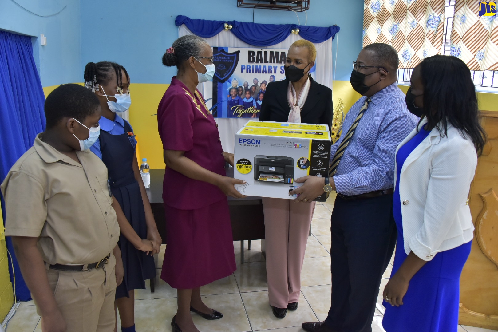 Minister of Education and Youth, Hon. Fayval Williams (third right), looks on as Principal, Balmagie Primary School, Vinette Simms (third left), is presented with a printer donated by the Usain Bolt Foundation, by Member of Parliament for Western St. Andrew, Anthony Hylton (second right), during a ceremony held at the school on March 17. Others from left are students Damion Rowe and Deena-Kay Cole, and teacher at the school, Naomi Biggs Gayle.
