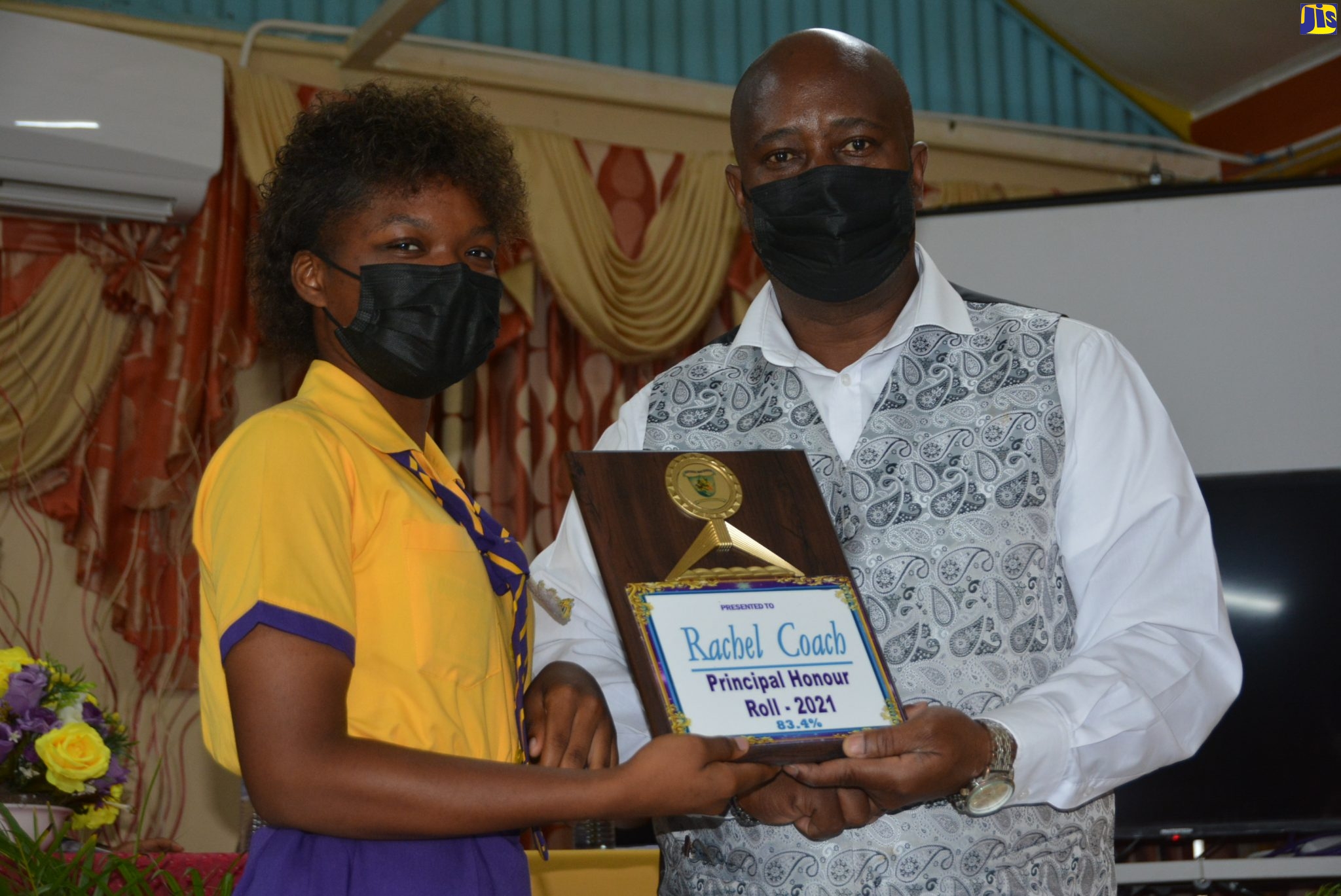 Hopewell High School’s Principal, Byron Grant, presents an award to Principal Honour Roll student, Rachel Coach, during the institution’s prize-giving ceremony on Thursday (March 17).
