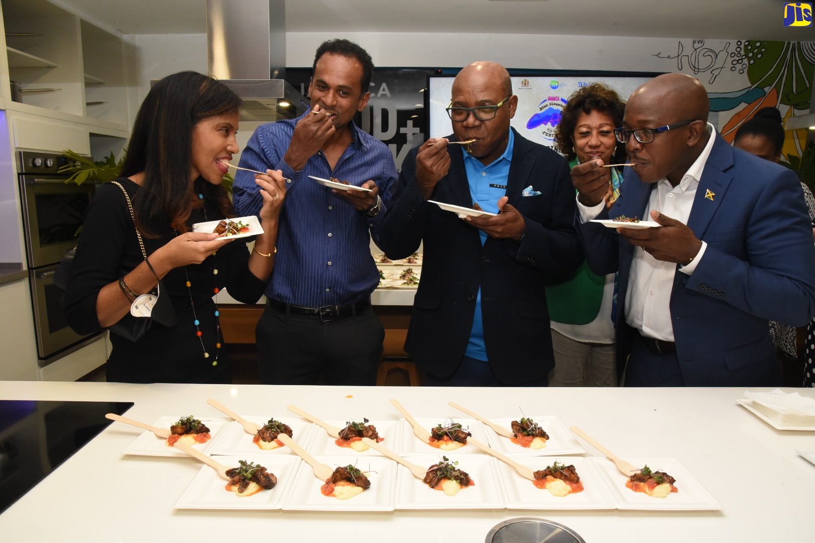 Minister of Tourism, Hon. Edmund Bartlett (centre), samples cuisine infused with coffee during the launch of the Jamaica Blue Mountain Coffee Festival on Tuesday (March 1) at the Jamaica Food and Drink Kitchen, Progressive Plaza, on Barbican Road in St. Andrew. He is joined by (from left), Chairperson, Gastronomy Network, Nicola Madden-Greig; Executive Director, Tourism Enhancement Fund (TEF), Dr. Carey Wallace; President of Jamaica Promotions Corporation (JAMPRO), Dian Edwards (in background); and Minister of Agriculture and Fisheries, Hon. Pearnel Charles Jr.