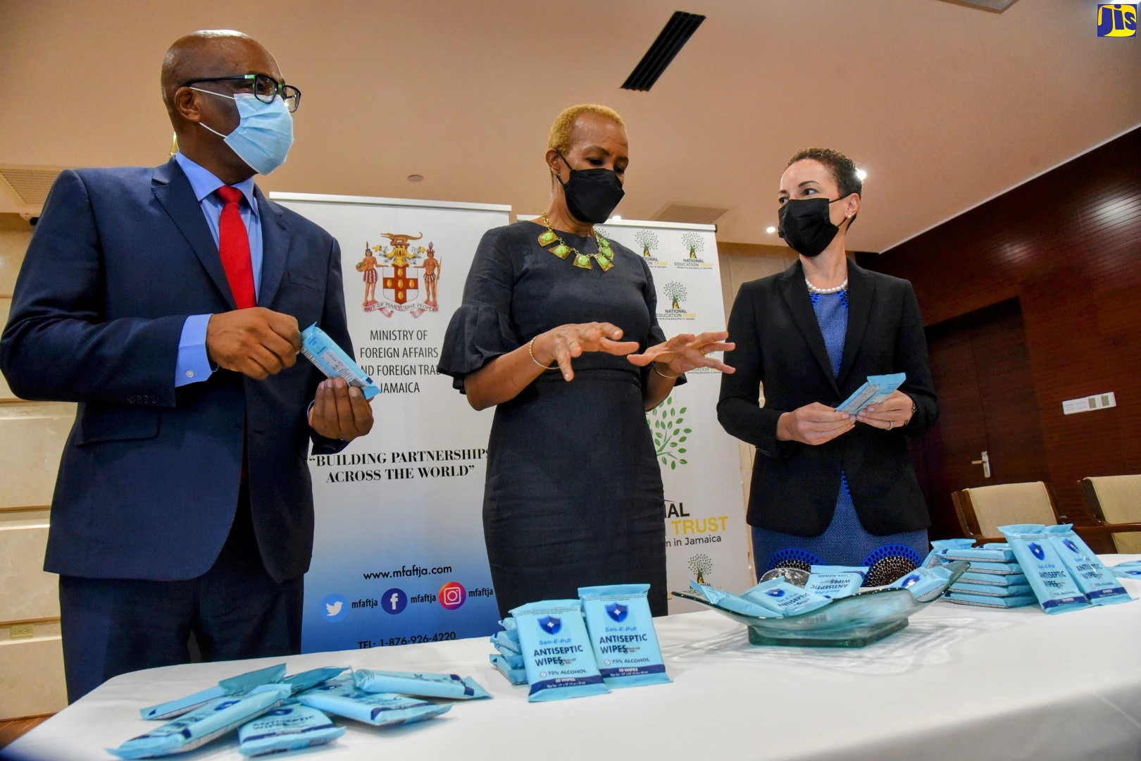 Minister of Education and Youth, Hon. Fayval Williams (centre), is in discussion with Minister of Foreign Affairs and Foreign Trade, Senator the Hon. Kamina Johnson Smith (right), and Minister of State in the Ministry of Foreign Affairs and Foreign Trade, Senator Leslie Campbell, during a recent ceremony to hand over antiseptic wipes donated by Jamaica’s Consul General of New York, Alsion Roache Wilson, at the Foreign Ministry’s headquarters in downtown Kingston, recently. The special partnership project was undertaken as part of the Consulate General of Jamaica, New York’s Economic Diplomacy and Social/COVID-19 Programme.  The aim of the programme is to leverage the Consulate General’s diplomatic connections and network for the socio-economic development of Jamaica.