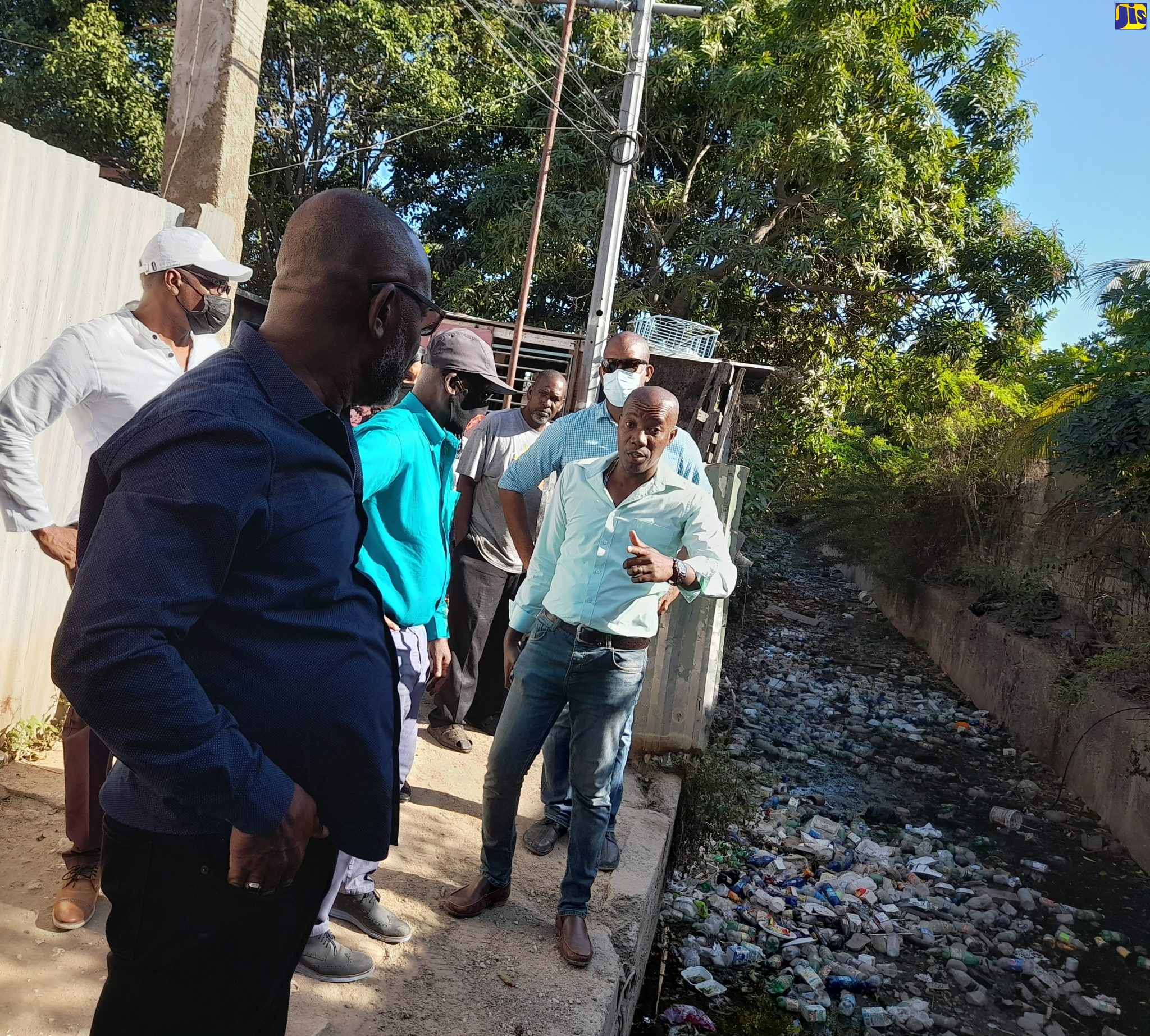 Minister of Local Government and Rural Development, Hon. Desmond McKenzie (third left), listens to Councillor for the Independence City Division, Courtney Edwards (right), while on a recent tour of the Texas Avenue community in Portmore, St. Catherine. In the foreground is Mayor of Portmore, Leon Thomas, and behind Mr. Edwards is Member of Parliament for St. Catherine South East, Robert Miller.