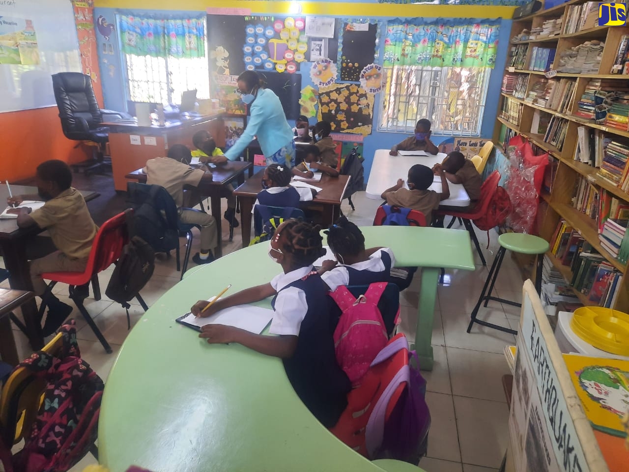 Enrichment Centre teacher at the Petersfield Primary and Infant School in Westmoreland, Dorcas Myrie (in background), instructs students in the group at the school recently. 