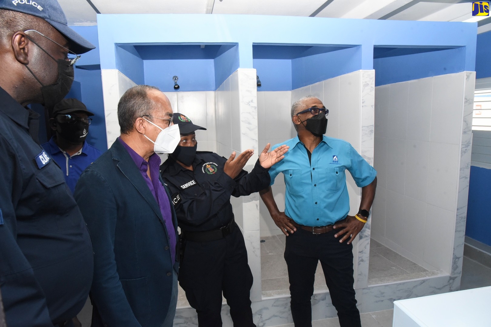 Minister of National Security, Hon. Dr. Horace Chang (second left), looks on as Superintendent of Police, Sherika Service (second right), points out features of a renovated bathroom at Harman Barracks in Kingston, during a tour, recently. He is joined by (from left): Head of the Specialised Operations Branch of the Jamaica Constabulary Force (JCF), Assistant Commissioner of Police (ACP), Warren Clarke; and Senior General Manager at the National Housing Trust (NHT), Donald Moore.