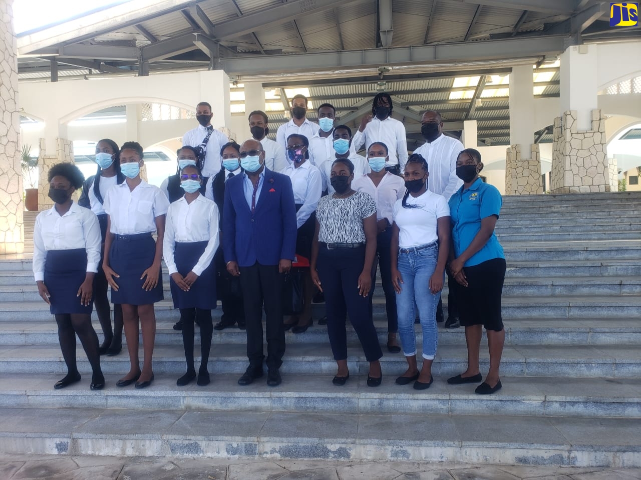 Minister of Tourism, Hon. Edmund Bartlett, (front row, centre) is photographed with some recent graduates of the Hospitality and Tourism Management Programme (HTMP), after a press briefing held at the Montego Bay Convention Centre in St. James on Friday (March 11).