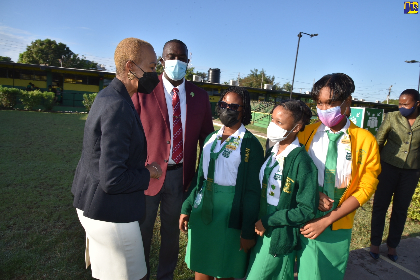 Minister of Education and Youth, Hon. Faval Williams (left), and Principal of the Old Harbour High School, Lynton Weir (second left), welcome students as they return to full face-to-face learning at the St. Catherine-based institution on Monday (March 7)