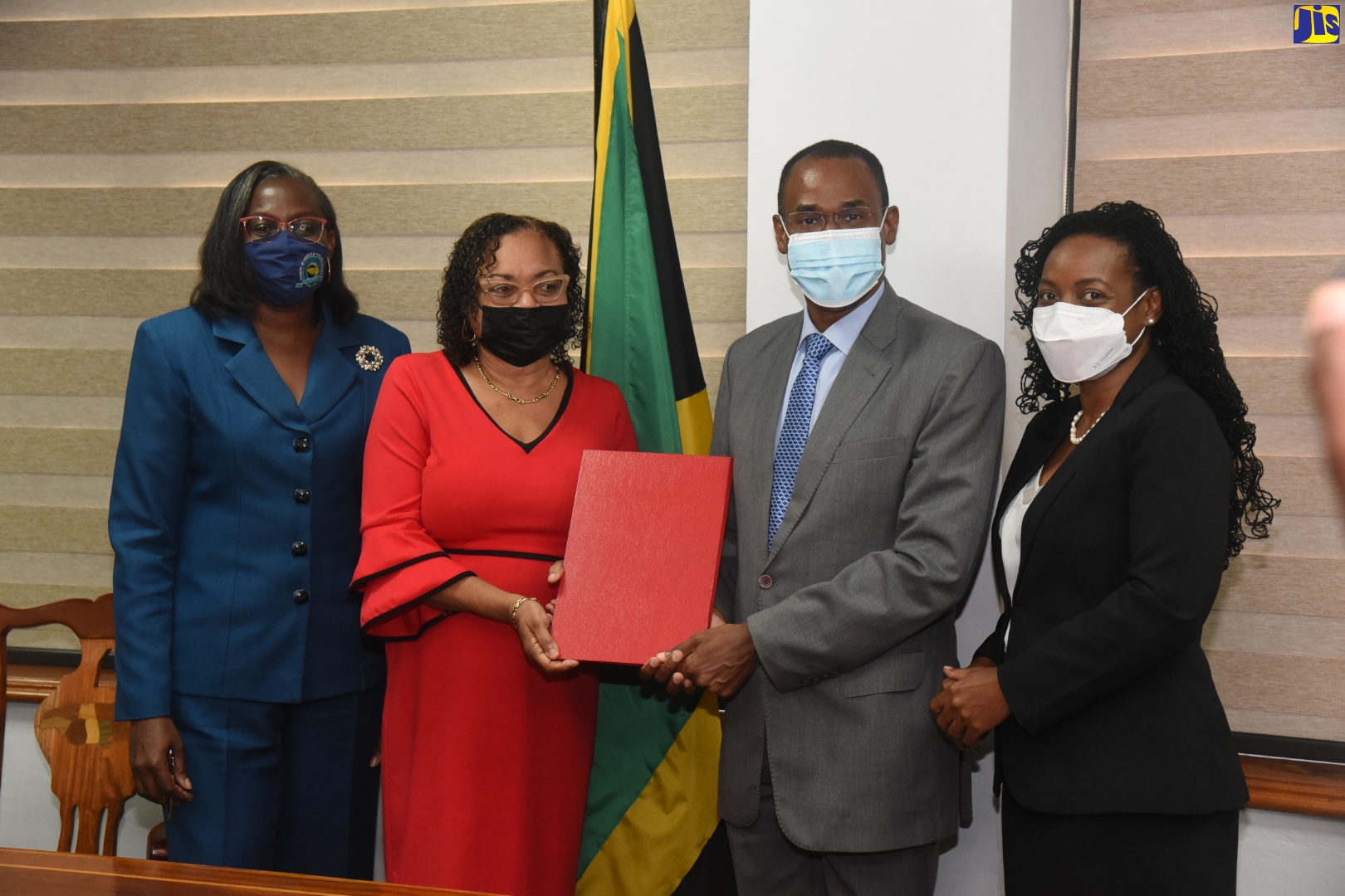 Minister of Finance and the Public Service, Dr. the Hon Nigel Clarke (second right), and Jamaica Confederation of Trade Unions (JCTU) President, Helene Davis Whyte (second left), display the signed 2021/22 Heads of Agreement for wage increases for public-sector workers represented by JCTU affiliates. Others (from left) are Financial Secretary in the Ministry, Darlene Morrison, and State Minister, Hon. Marsha Smith.