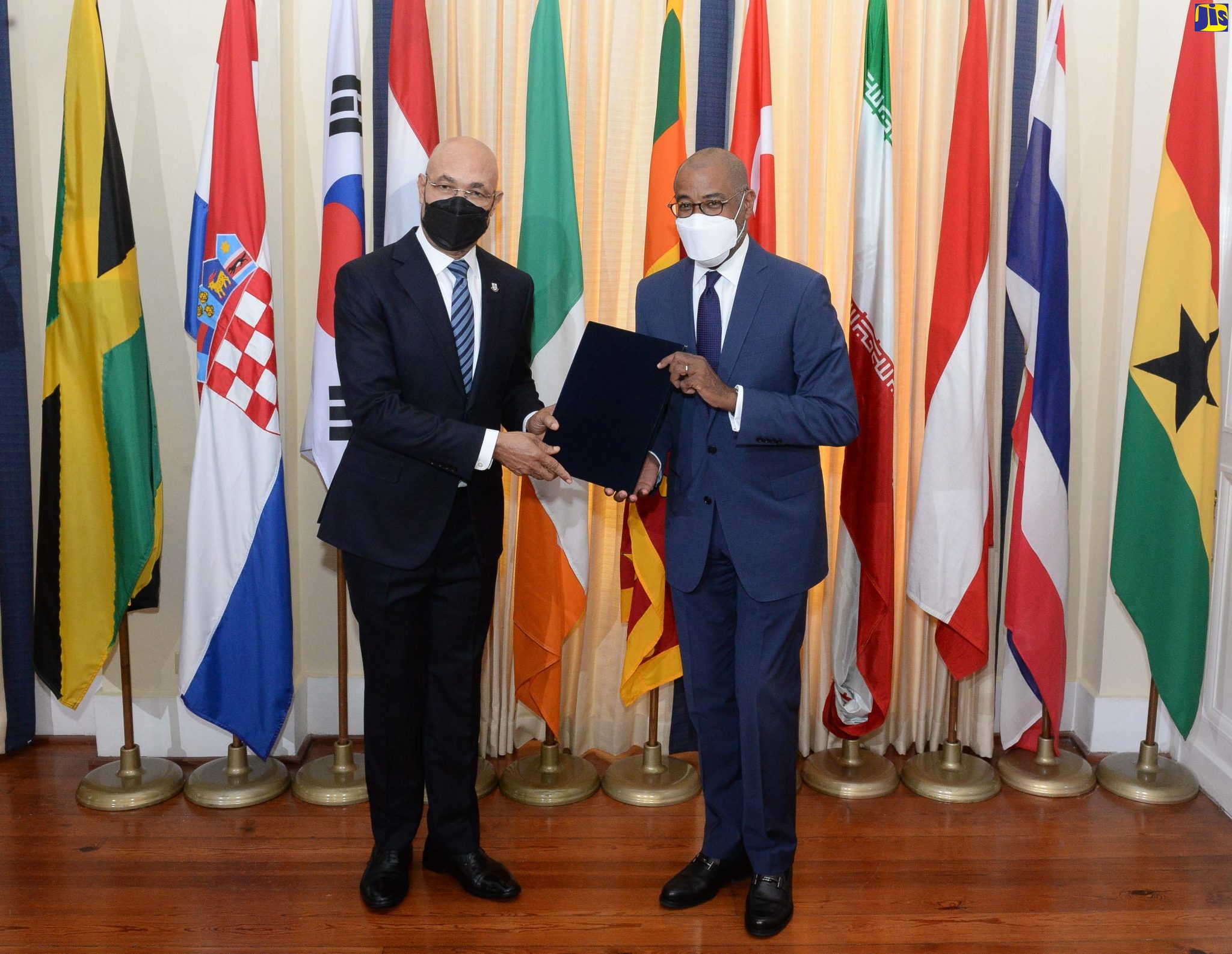 Governor-General, His Excellency, the Most Hon. Sir Patrick Allen (left), receives a portfolio containing the credentials for 10 Heads of Missions, from Director of Protocol, Ministry of Foreign Affairs and Foreign Trade, Ambassador Ricardo Allicock. The diplomats are Their Excellencies Ivan Šimonović, Republic of Croatia; Suh Jeong-in, Republic of Korea; Henricus Abram Starting, Kingdom of the Netherlands; Dr. Eamonn McKee, Republic of Ireland; Lakshitha Pradeep Ratnayake, Democratic Socialist Republic of Sri Lanka; Vehbi Esgel Etensel, Republic of Turkey; Seyed Mohammad Hadi Sobhani, Islamic Republic of Iran; Sylvia Meier-Kajbic, Republic of Austria; Kallayana Vipattipumiprates, Kingdom of Thailand; and Samuel Yaw Nsiah, Republic of Ghana. The presentation, which was made at King’s House on Tuesday (March 8), formed part of the Ministry’s activities marking Diplomatic Week 2022 from March 8 to 10, under the theme ‘Reigniting a Nation: Global Excellence, Our Mission’.