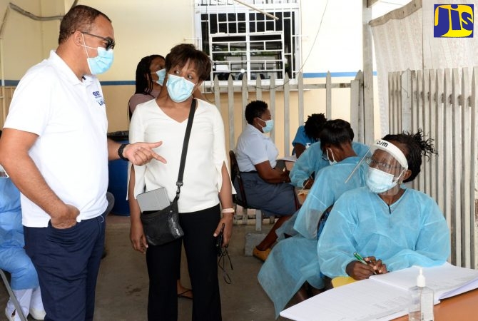 Minister of Health and Wellness, Dr. the Hon. Christopher Tufton, is in discussion with Senior Medical Officer at the Spanish Town Hospital, Dr. Jacqueline Wright-James (centre), and Community Health Aide (CHA), Sophia Manderson, during a recent visit to the health facility in St. Catherine.