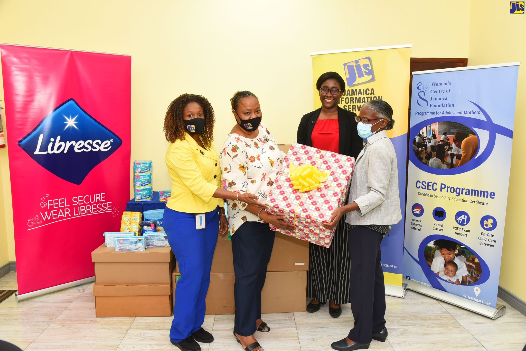 Public Relations and Marketing Manager at the Jamaica Information Service (JIS), Andrea Braham ( left), is joined by team members Joan Gayle (left) and Twila Wheelan, in handing over sanitary products to the Executive Director of the Women’s Centre of Jamaica Foundation (WCJF), Dr. Zoe Simpson (right). The presentation was made at the WCJF’s Trafalgar Road offices in Kingston on Wednesday (March 30 