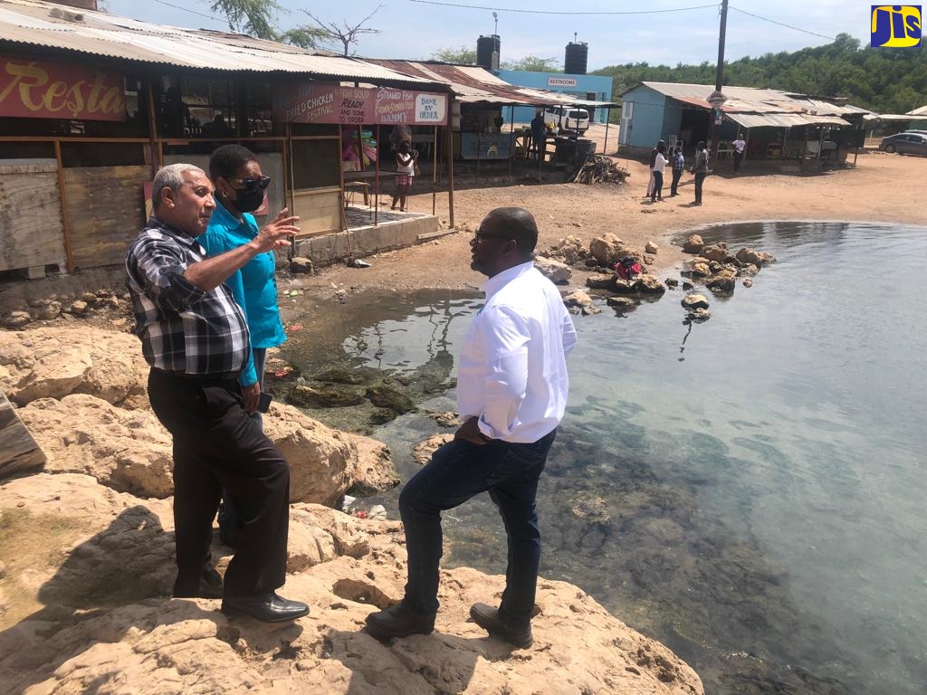 Mayor of May Pen, His Worship Councillor Winston Maragh (centre) in conversation with Executive Director, Tourism Product Development Company (TPDCo), Wade Mars (right) and Corporate Communications and Community Awareness Coordinator, TPDCo, Marline Stephenson Dalley (left), during a tour of the Salt River Mineral Spa in Clarendon on Friday (March 4). 