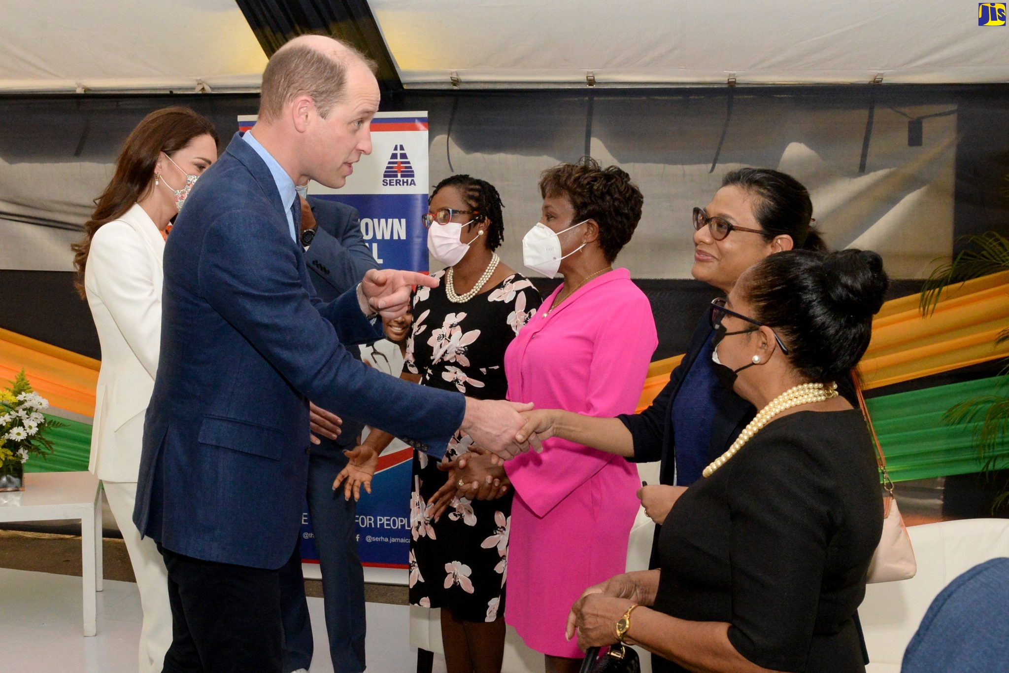 His Royal Highness, The Duke of Cambridge (second left), shares a warm handshake with Chief Medical Officer (CMO), Dr. Jacquiline Bisasor-McKenzie (second right), upon arrival at the Spanish Town Hospital in St. Catherine on Wednesday (March 23), for a tour of the facility.  At left, Her Royal Highness, the Duchess of Cambridge, exchanges pleasantries with Chief Executive Officer (CEO) of the hospital, Jacqueline Ellis (third left);  and the hospital’s Senior Medical Officer, Jacqueline Wright James. Looking on at  right is Custos Rotolorum of St. Catherine, Hon. Icylin Golding. Their Royal Highnesses’ visit to the Spanish Town Hospital is part of the schedule of activities for their Official Visit to Jamaica from March 22 to 24. The Official Visit forms part of celebrations marking the 70th Anniversary (Platinum Jubilee) of the Coronation of Her Majesty The Queen.